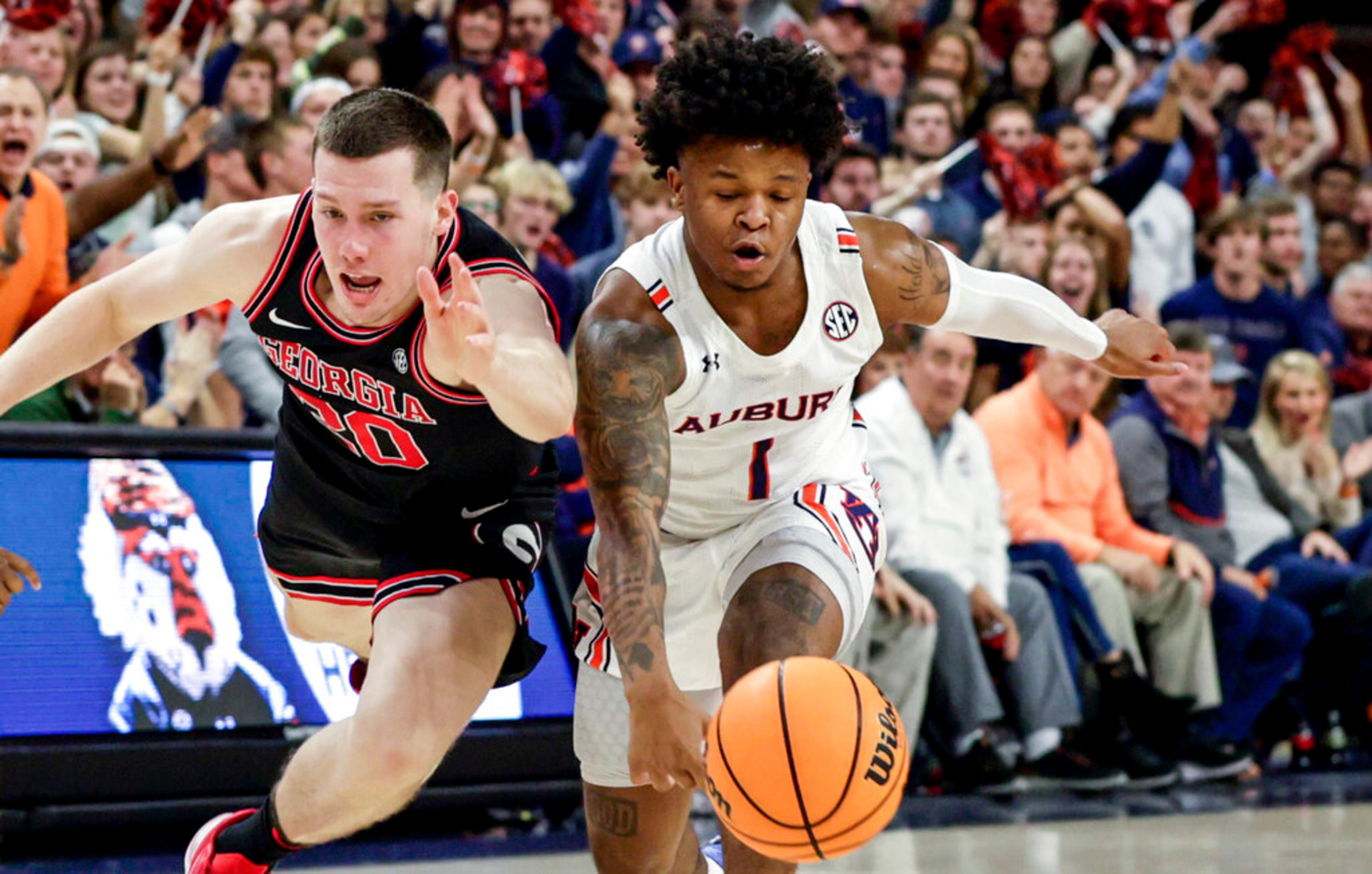 Auburn guard Wendell Green Jr. (1) steals the ball from Georgia guard Noah Baumann (20) during the first half of an NCAA college basketball game Wednesday, Jan. 19, 2022, in Auburn, Ala. (AP Photo/Butch Dill)