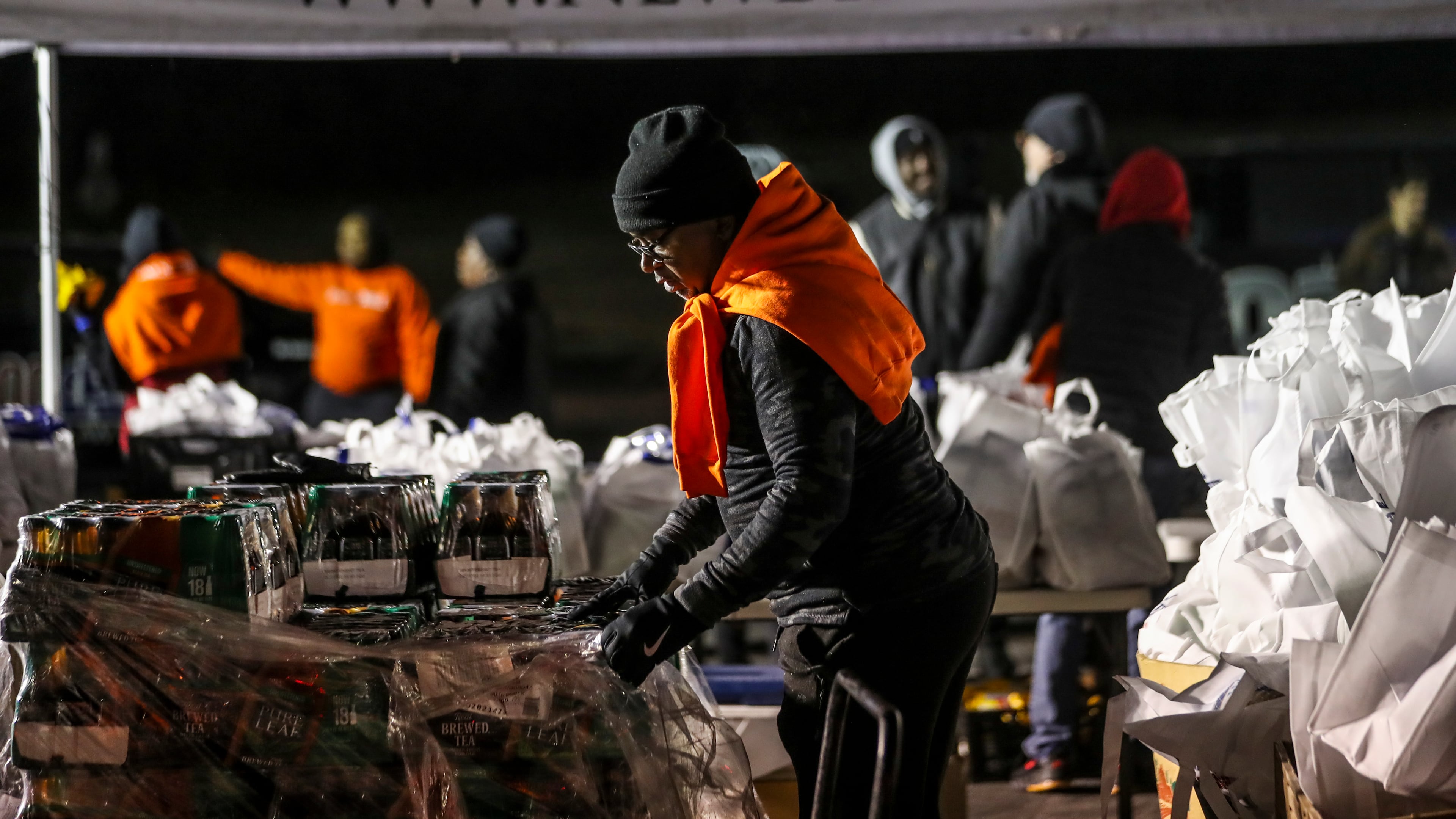 Alonzo Hill gets items ready at the turkey bag prep section. The King’s Table Annual Holiday Turkey Giveaway Thursday morning took place on Thursday morning at 6am on Nov. 17, 2022 at New Birth Missionary Baptist Church located at 6400 Woodrow Road in Stonecrest. The Witherite Law Group, 1-800-TruckWreck, Atlanta’s prominent hip hop and R&B radio stations including V-103 The People’s Station and New Birth Missionary Baptist Church hosted the annual event that provided food on a first come first serve basis for some 2,200 people. Thanksgiving meal boxes provided to the arriving motorists who waited in long lines, included turkeys in 20-pound boxes that were filled with fresh fruits, vegetables and shelf-stable food items for families financially strained. (John Spink / John.Spink@ajc.com)