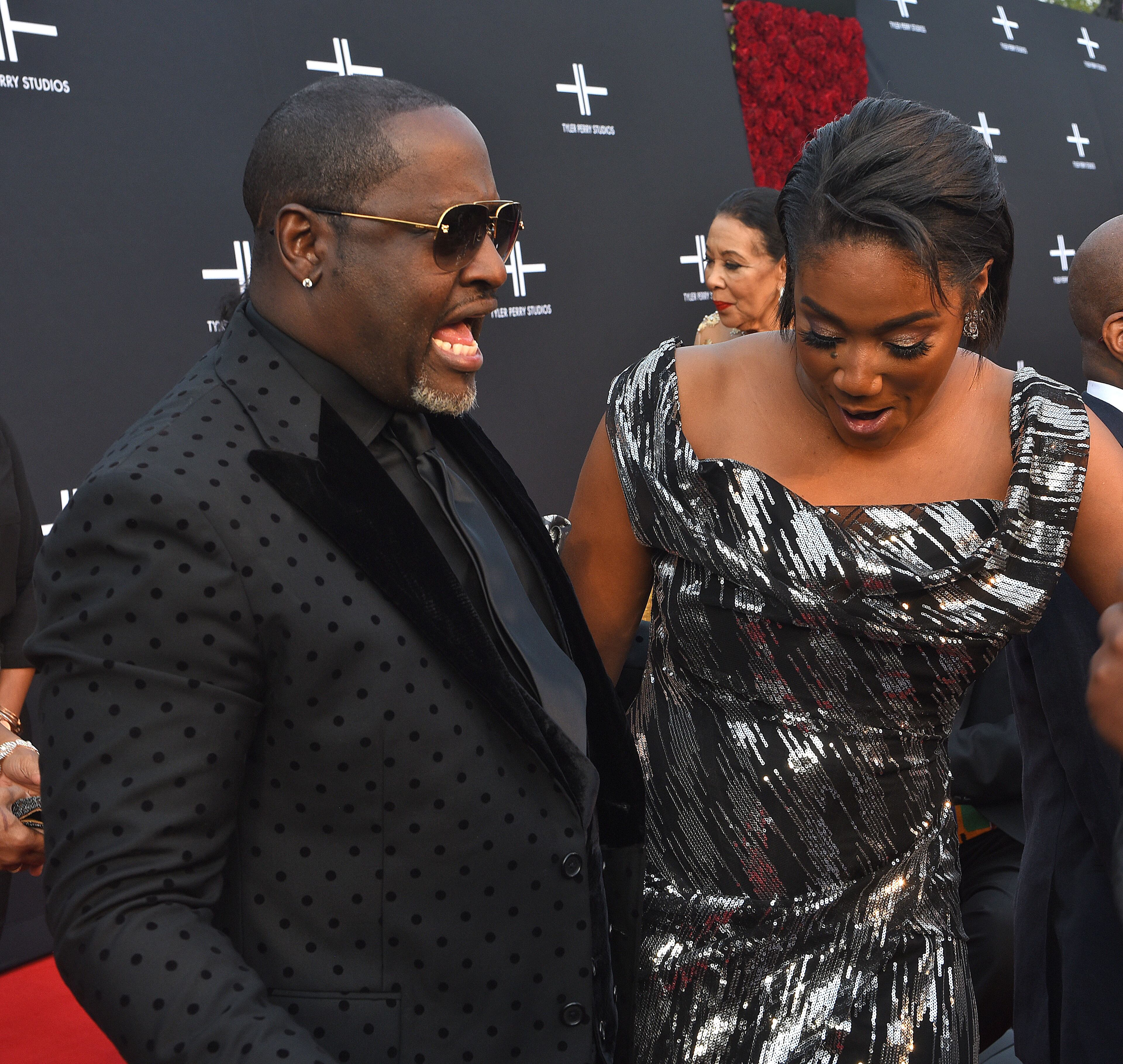October 5, 2019 Atlanta - Comedian, actress Tiffany Haddish (right) gives singer Johnny Gill a once over on the red carpet for the opening of Tyler Perry Studios Saturday, October 5, 2019 in Atlanta. Perry acquired the property of Fort McPherson to build a movie studio on 330 acres of land. (Ryon Horne / Ryon.Horne@ajc.com)