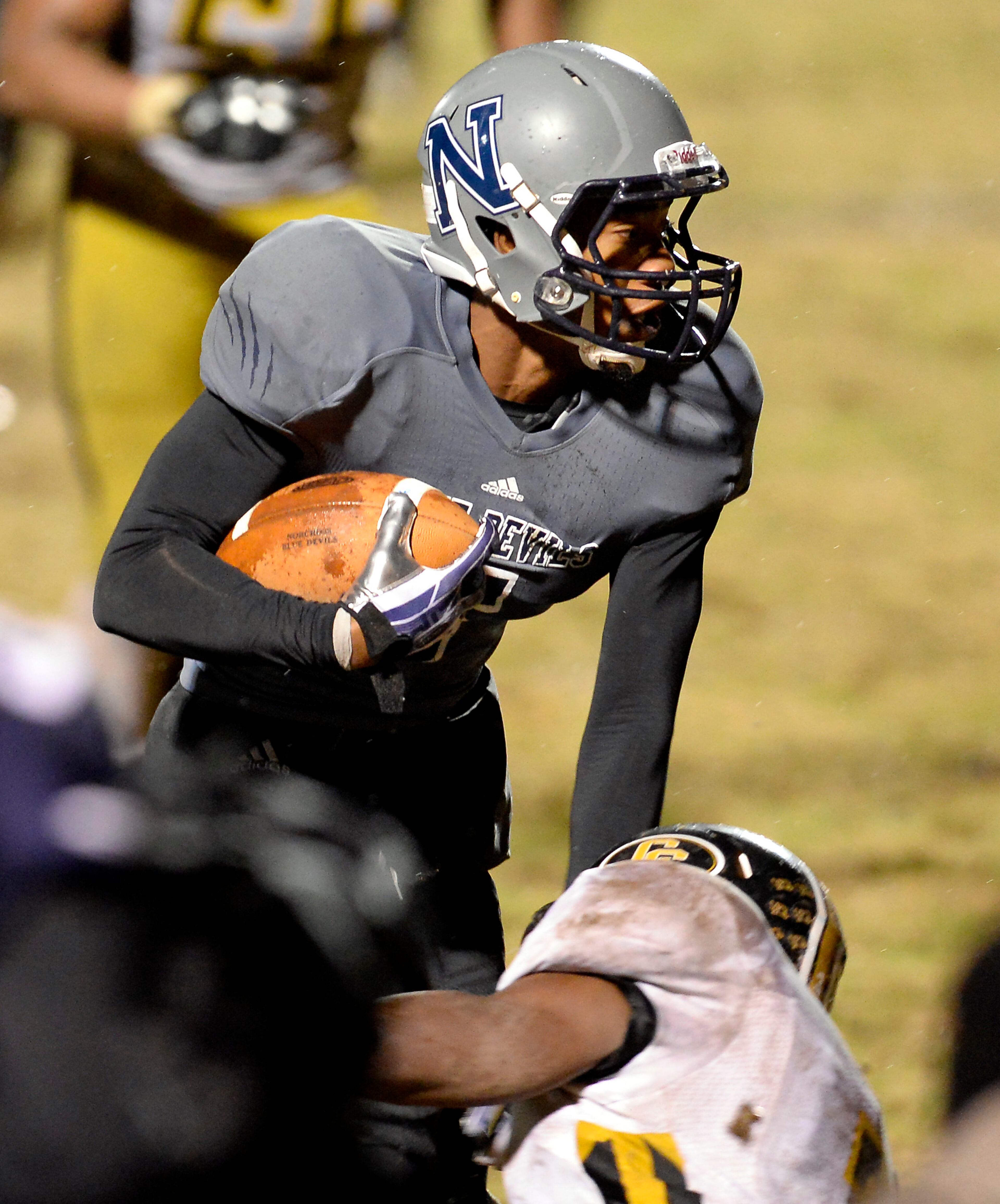 Norcross running back Miles Autry (5) evades a tackle by Colquitt on his long touchdown run that put Norcross ahead 13-9 before the PAT in the second half of their AAAAAA semifinal game at Blue Devil Stadium on Friday, Dec. 6, 2013, in Norcross, Ga.