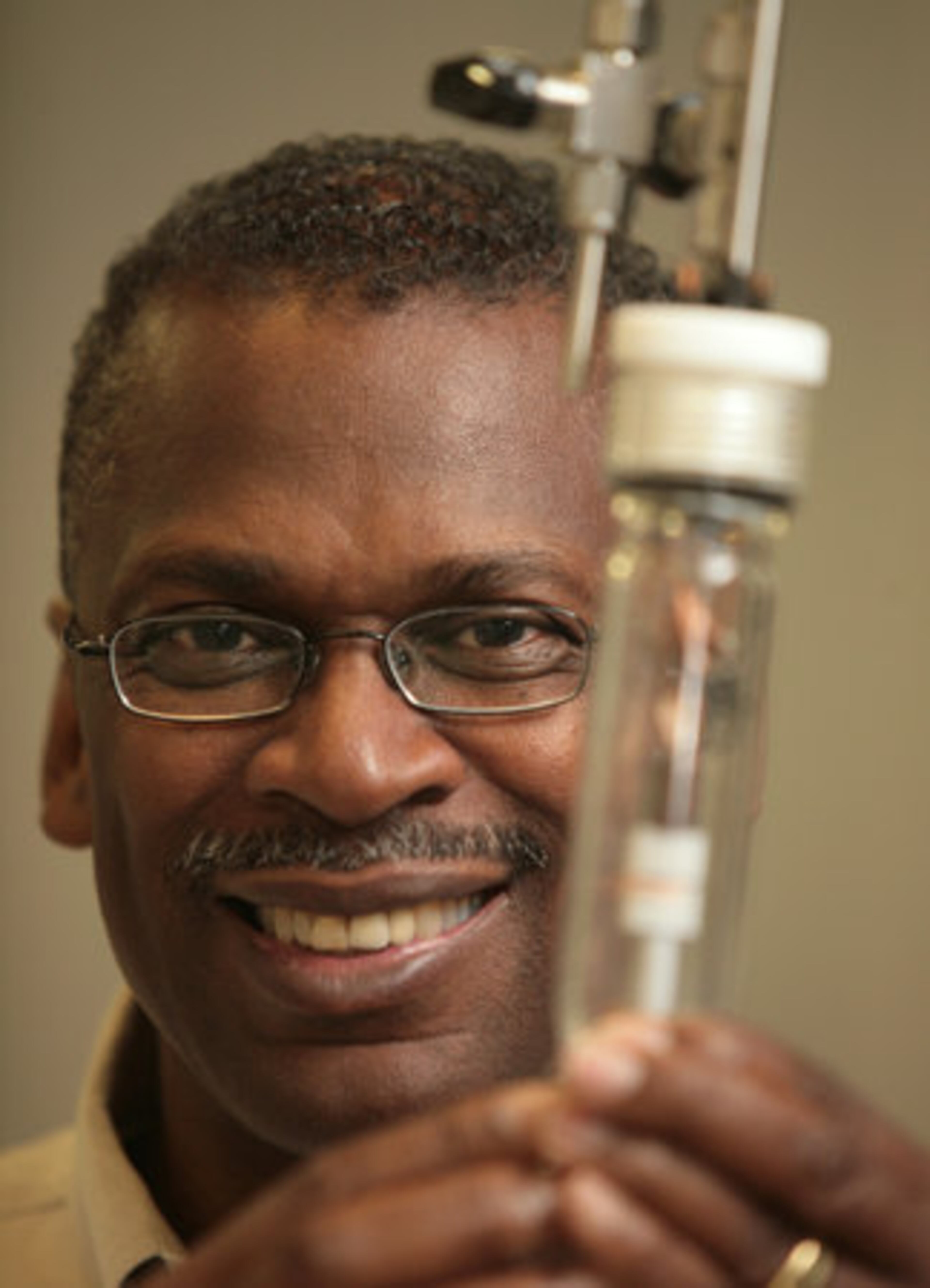 Lonnie Johnson holds a lithium battery test chamber in his labs in downtown Atlanta.