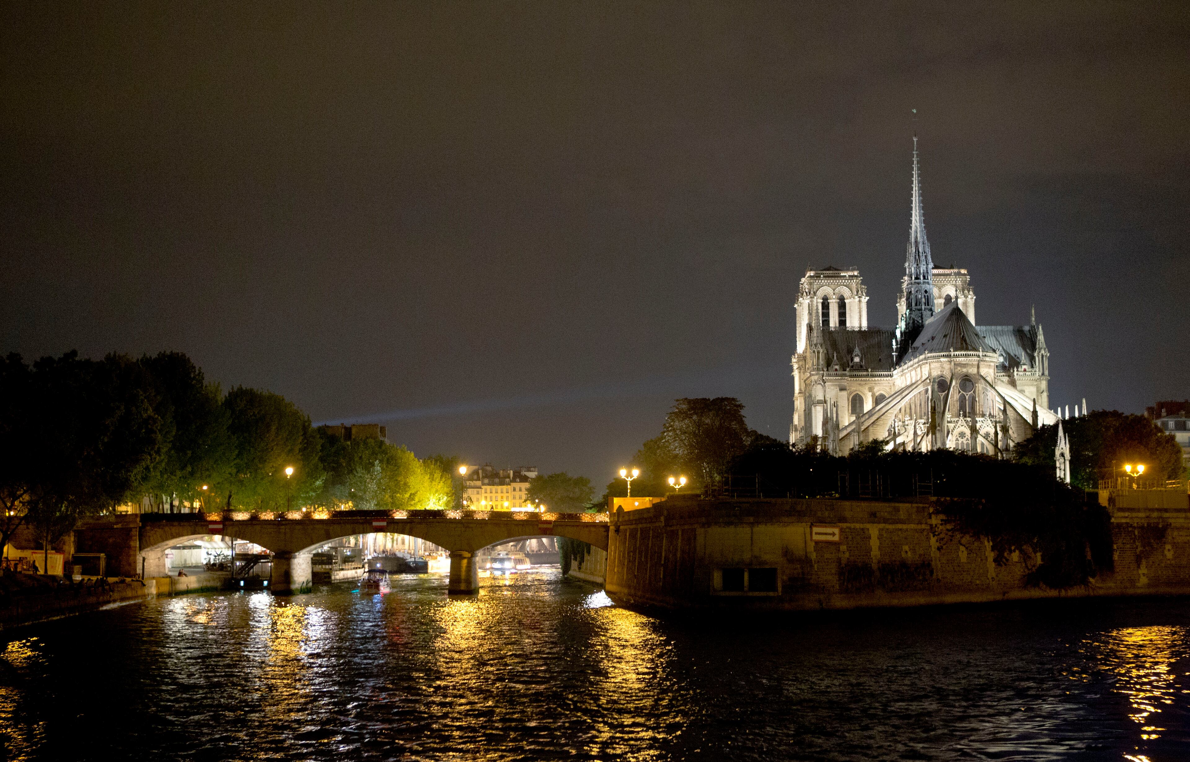 View of the Notre Dame Cathedral along the Seine river at nigth, in Paris, Wednesday, Sept. 17, 2014. (AP Photo/Jacques Brinon)