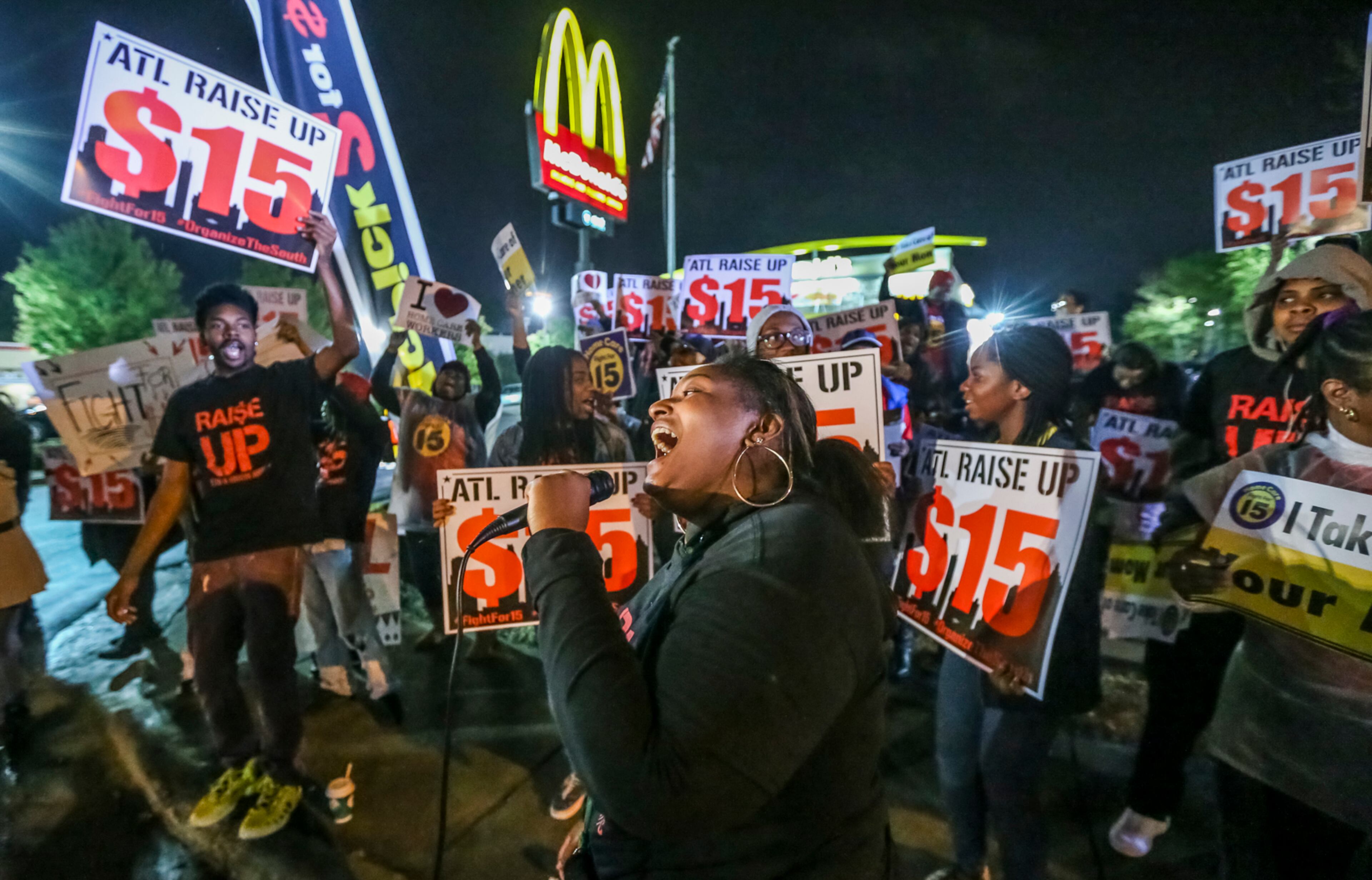 April 14, 2016 Atlanta: Jamie Banks (center) who says she works at Wendy's on Old National Highway leads the chants Thursday at the Northside Drive McDonald's in Atlanta. With momentum building off historic $15/hr wins in California, New York and Pennsylvania, Atlanta's fast food workers participated in rallies on Thursday, April 14 2016 calling on corporations pay wages they can live on and pay their fair share of taxes. Fast-food workers protested in Atlanta at 6 a.m., at the MacDonaldÕs on Northside Drive near 14th Street in Atlanta to demand $15 and hour wages and union rights. About 50-workers circled the building as they marched and chanted and then lined up in front of the restaurant carrying signs and chanting slogans. The demonstration lasted an hour. JOHN SPINK / JSPINK@AJC.COM.