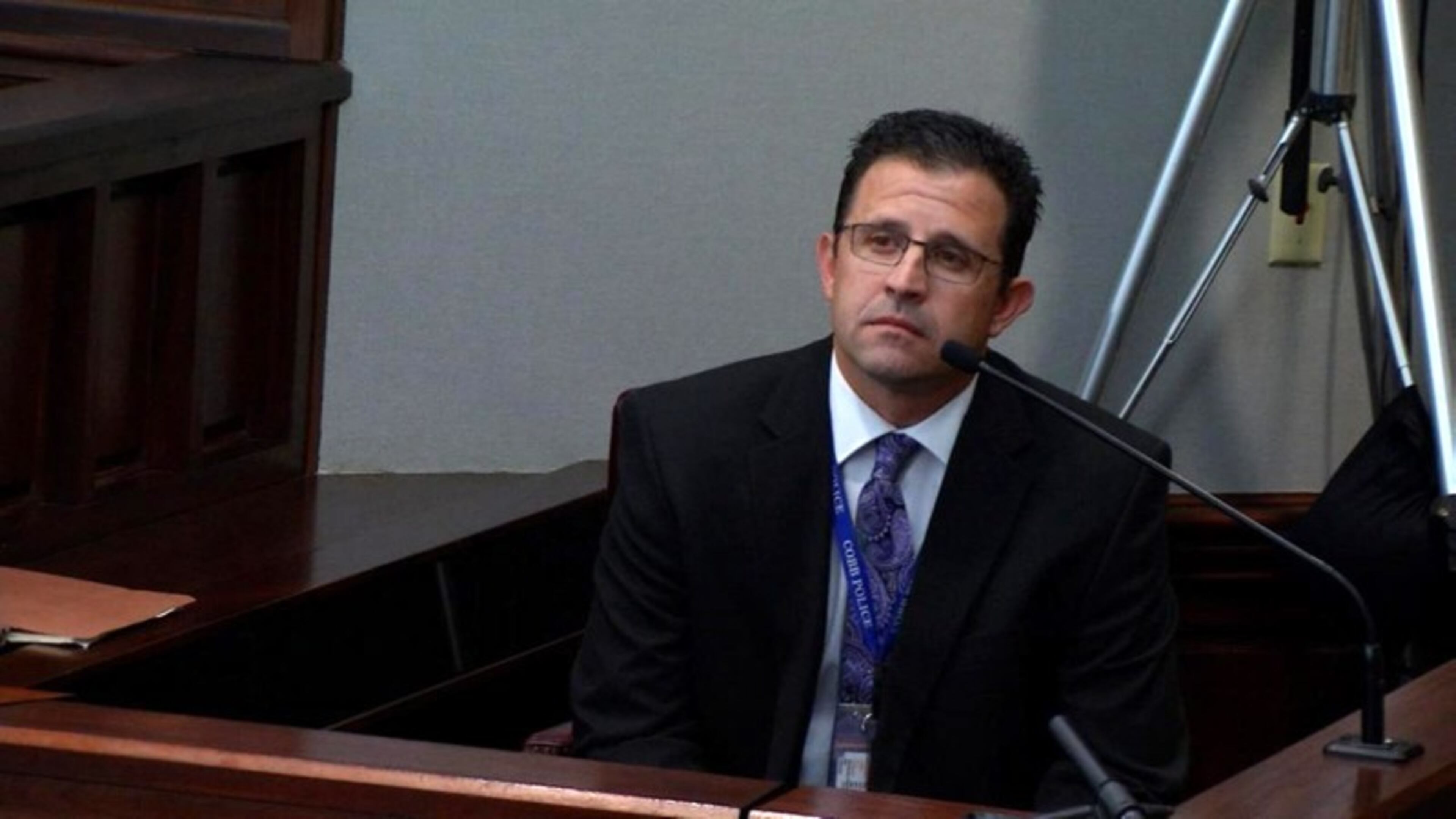 Cobb County Det. Edward Stockinger testifies Friday at the hot-car murder trial. Stockinger was the one who officially told Leanna Harris her son was dead. (screen capture from WSB-TV) WSB-TV