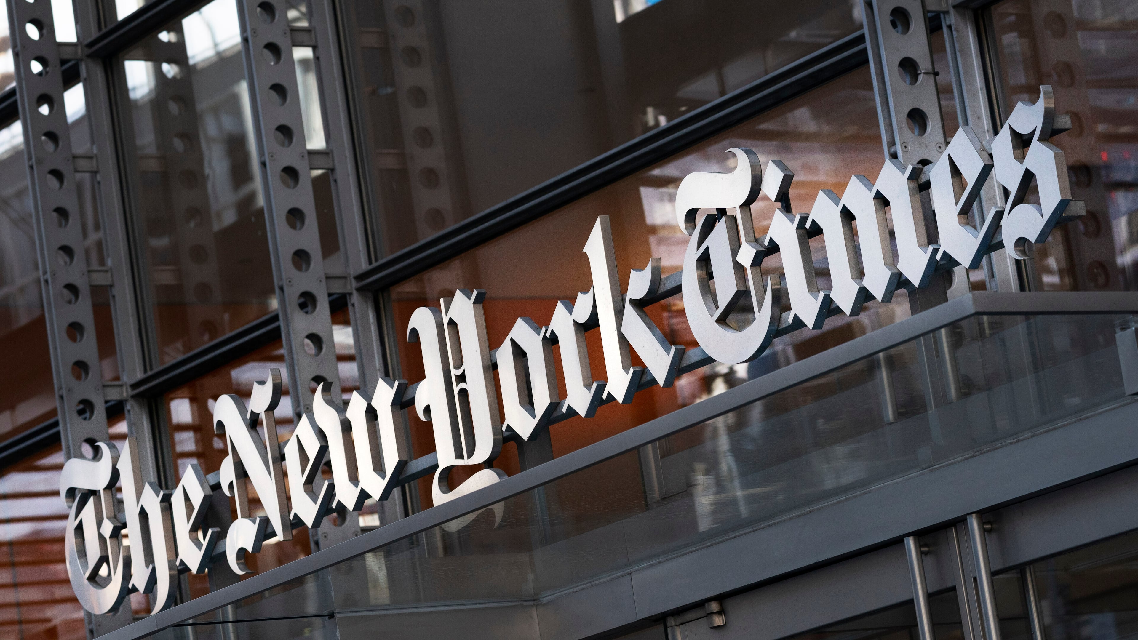 FILE - A sign for The New York Times is displayed above the entrance to its building in New York on May 6, 2021. (AP Photo/Mark Lennihan, File)