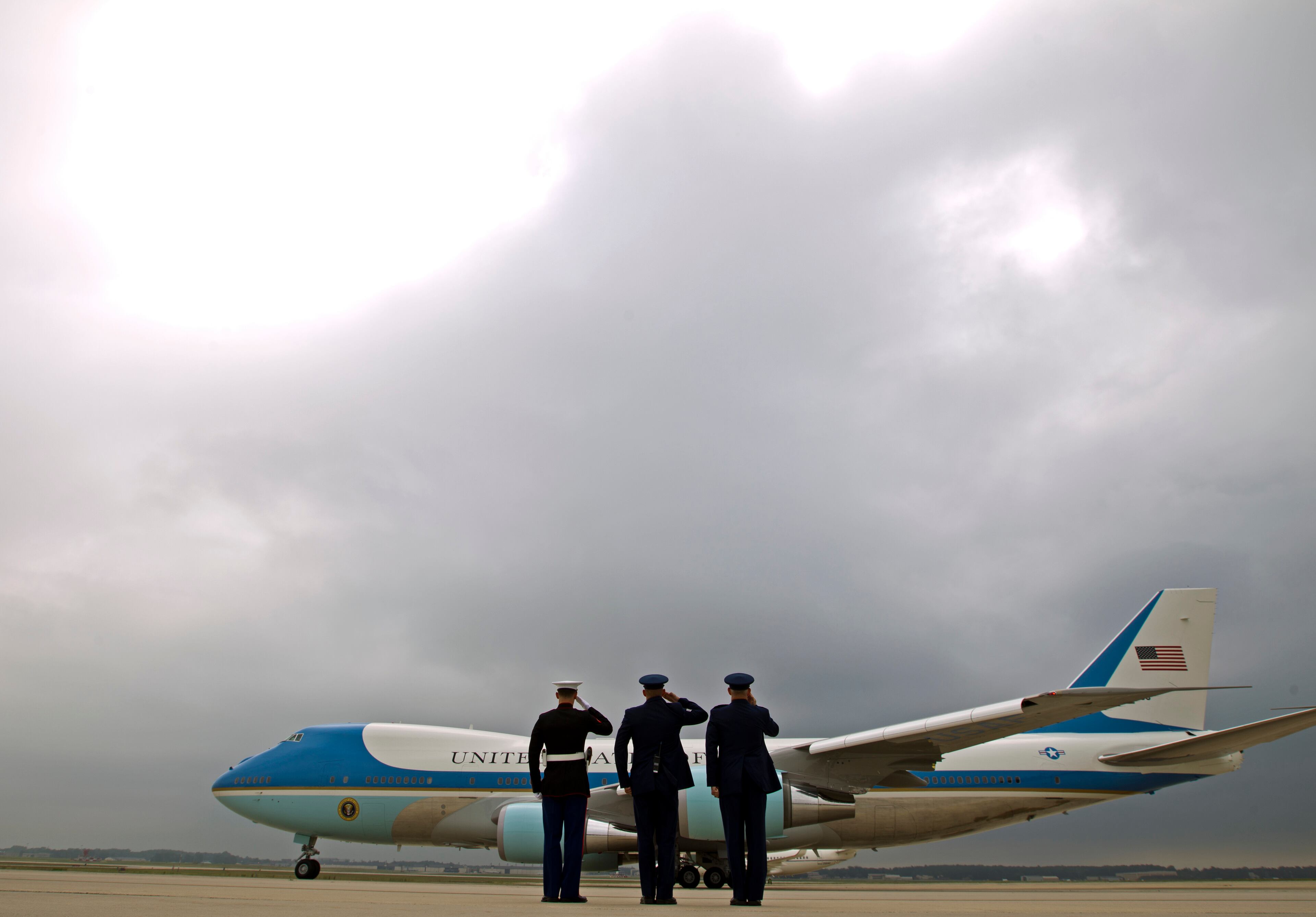 Military personnel salute as Air Force One, with President Barack Obama aboard, departs at Andrews Air Force Base, Md., Thursday, June 16, 2016, en route to Orlando to pay respects to the victims of the Pulse nightclub shooting and meet with families of victims of the attack. (AP Photo/Jose Luis Magana)