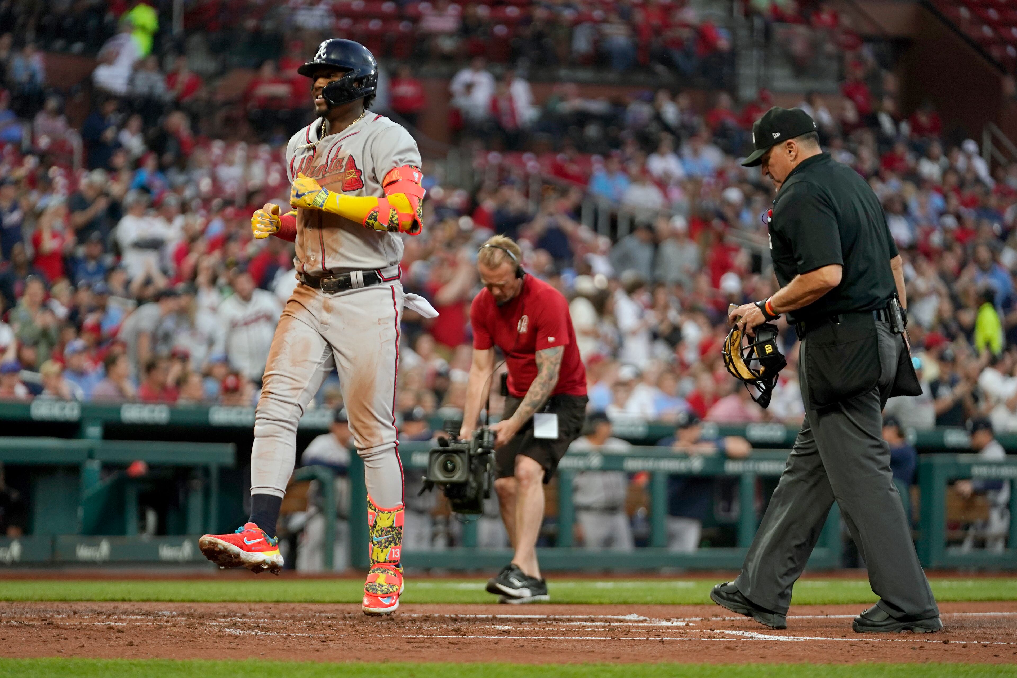 Ronald Acuna Jr. celebrates as he arrives home after hitting a three-run home run during the second inning of a baseball game against the St. Louis Cardinals Monday, April 3, 2023, in St. Louis.