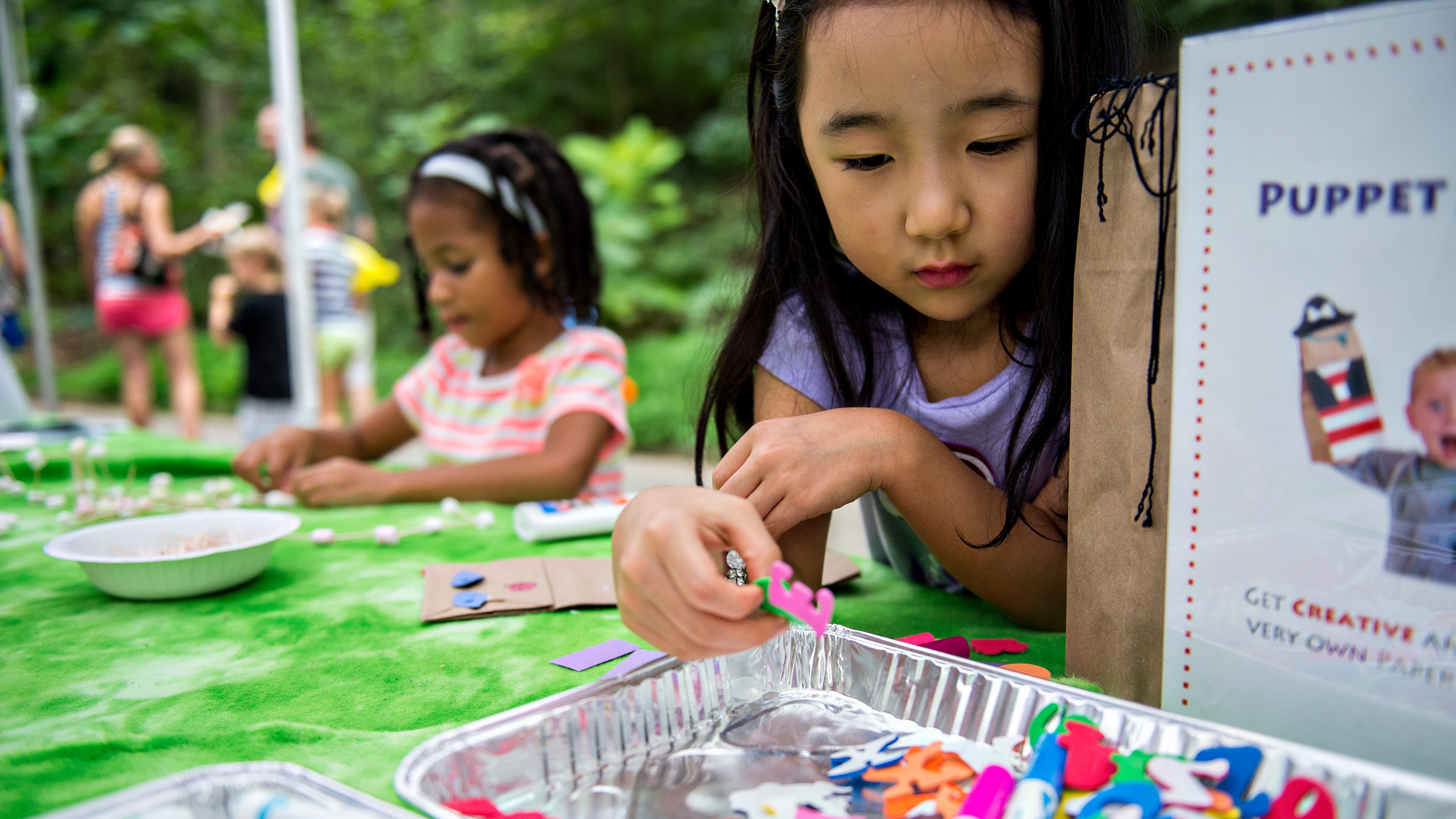 Lyn Choi (right) and Grey Garrett work on crafts during the 13th annual Grant Park Summer Shade Festival on Saturday, August 29, 2015. The two day festival featured some of Atlanta's most well known artists, live music, food and children's activities. JONATHAN PHILLIPS / SPECIAL