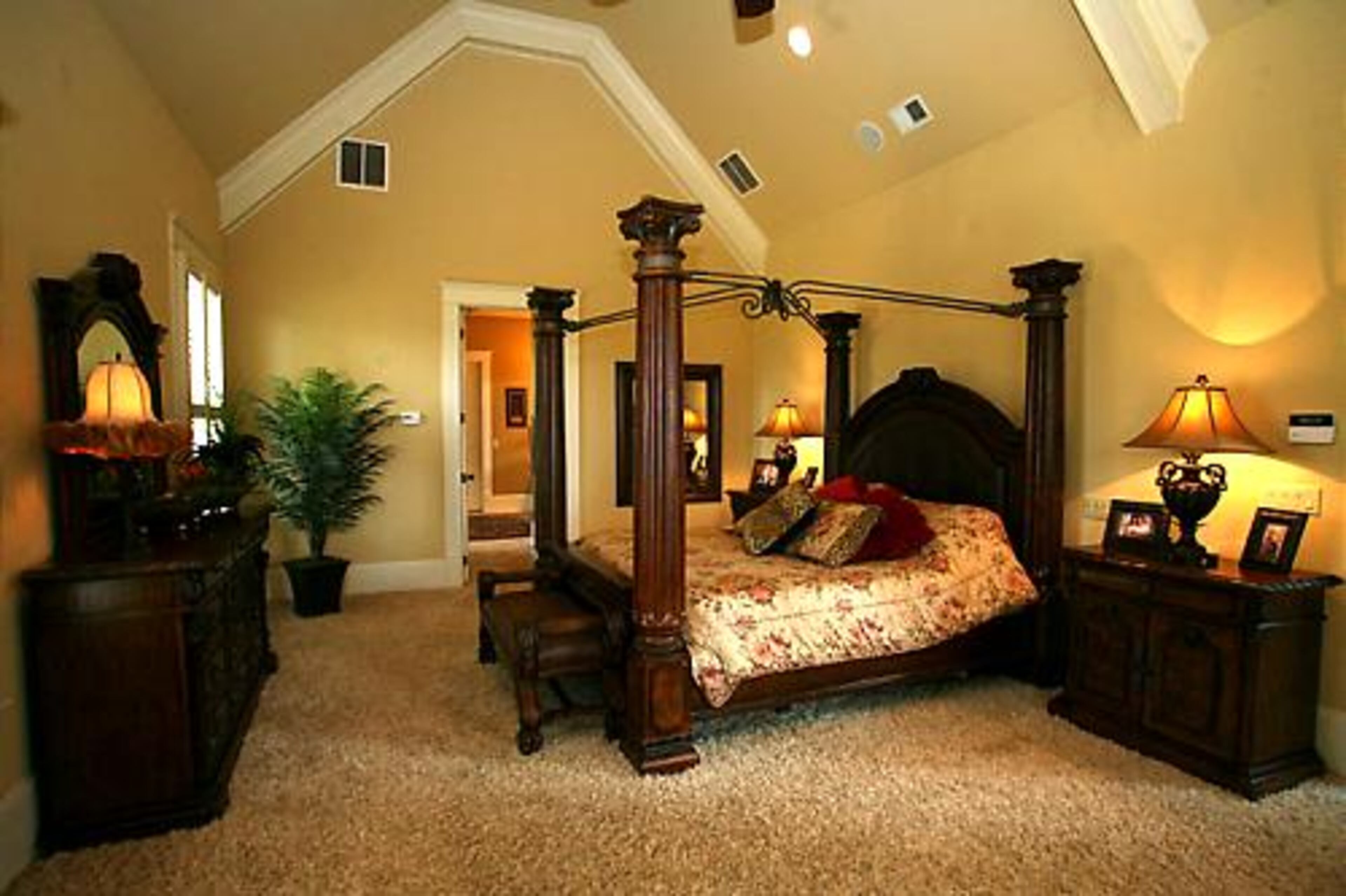 Shane and Pam enjoy a spacious master bedroom with high ceilings and a fireplace.