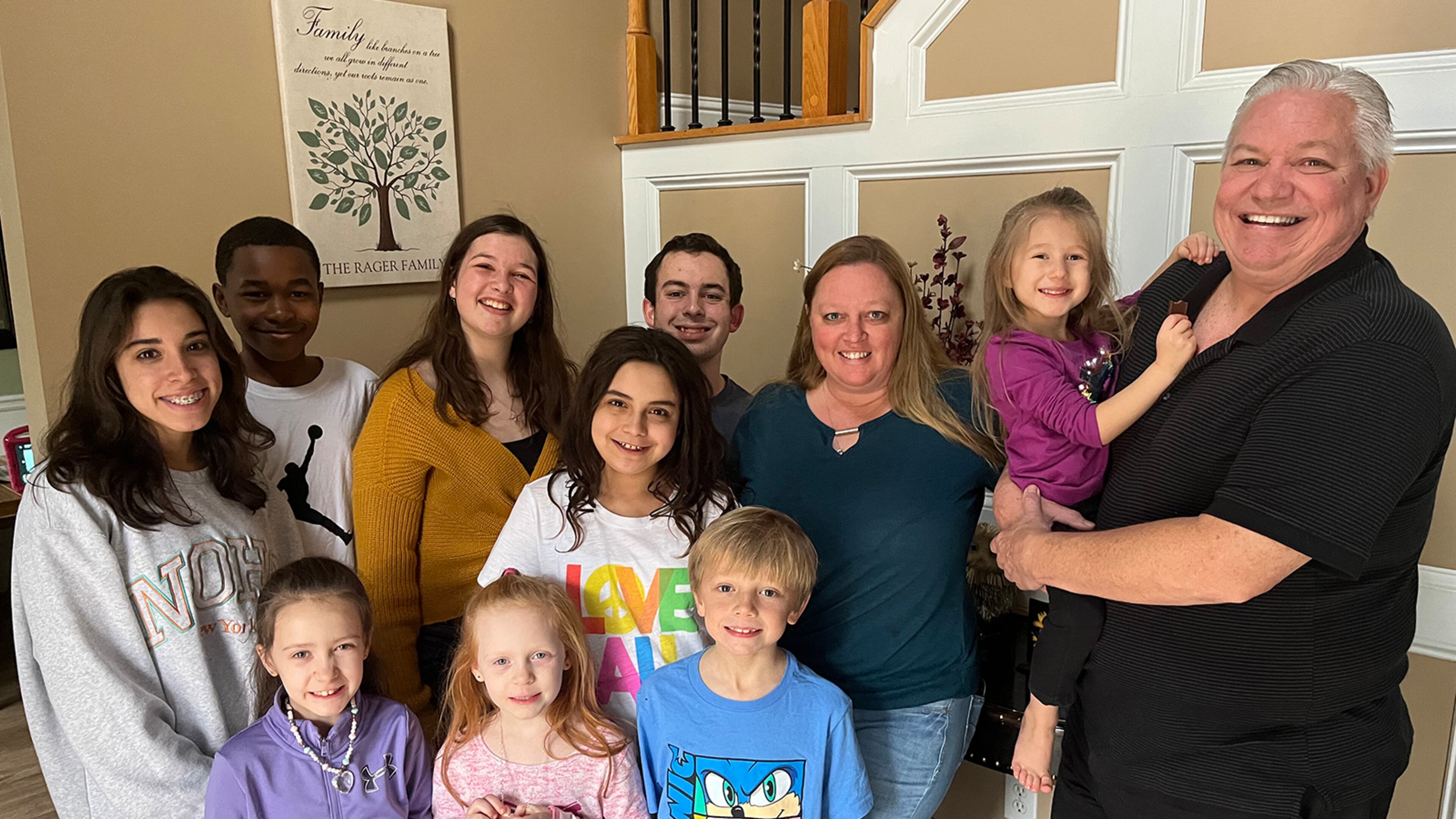 Lisa Rager knows well the hurdles to obtaining services for foster kids. She and her husband, Wes, have cared for more than 100 foster children and adopted 11 of them, many of whom are pictured. Rager says one child waited more than a year for an appointment to see a specialist doctor. (Andy Miller/KHN)