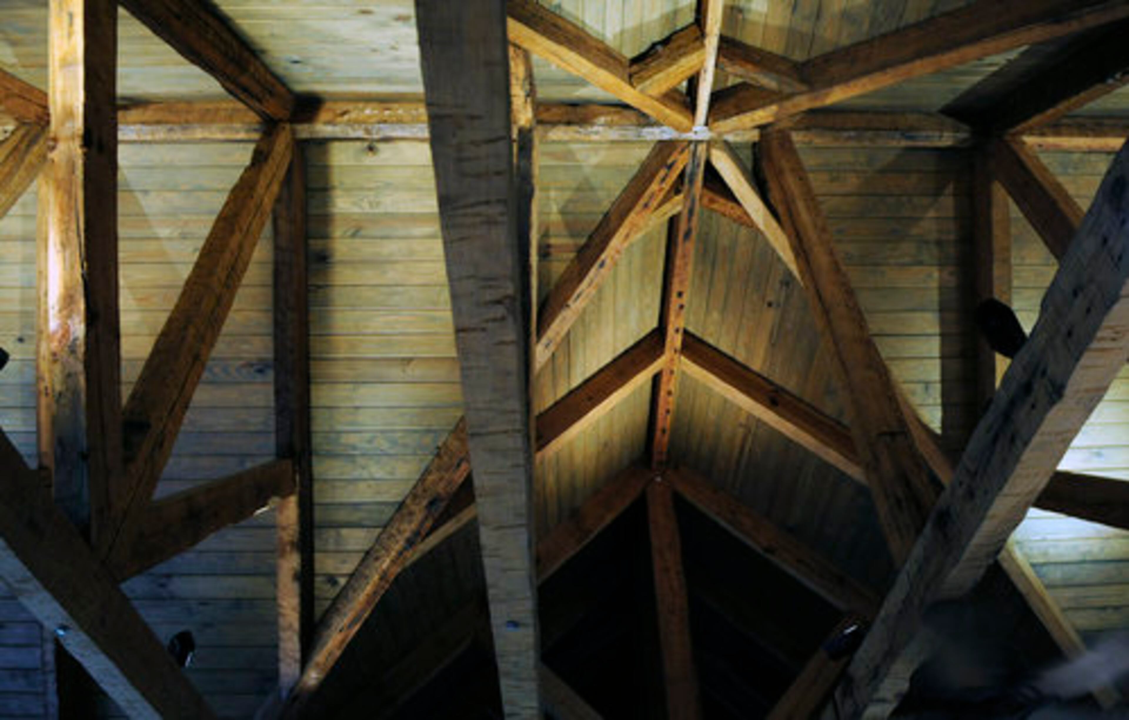 Exposed beams soaring overhead support the peaked 32-foot ceiling. The beams create their geometric patterns beneath a tin roof that makes any kind of weather a treat. "When it rains, it's just the best," Good said. Though the couple feels miles away from civilization, they can return to the bustle of Atlanta in 90 minutes, if they choose.