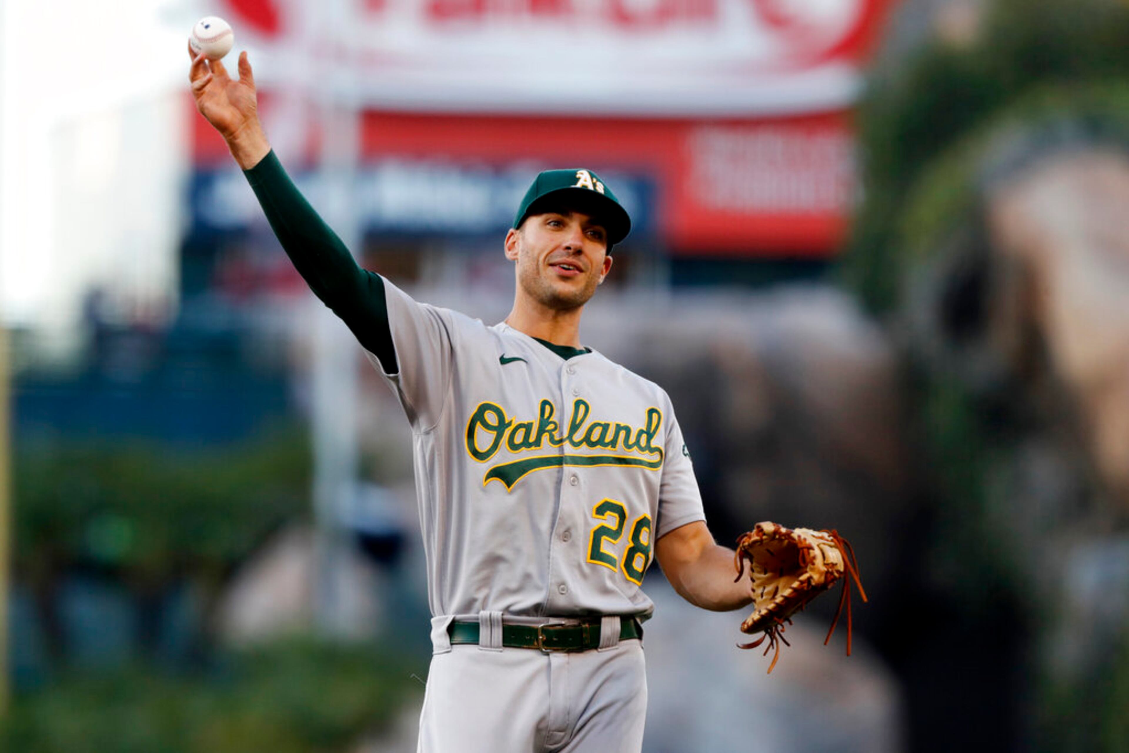 Oakland Athletics' Matt Olson throws to warm up before a baseball game against the Los Angeles Angels in Anaheim, Calif., Saturday, Sept. 18, 2021. (AP Photo/Alex Gallardo)