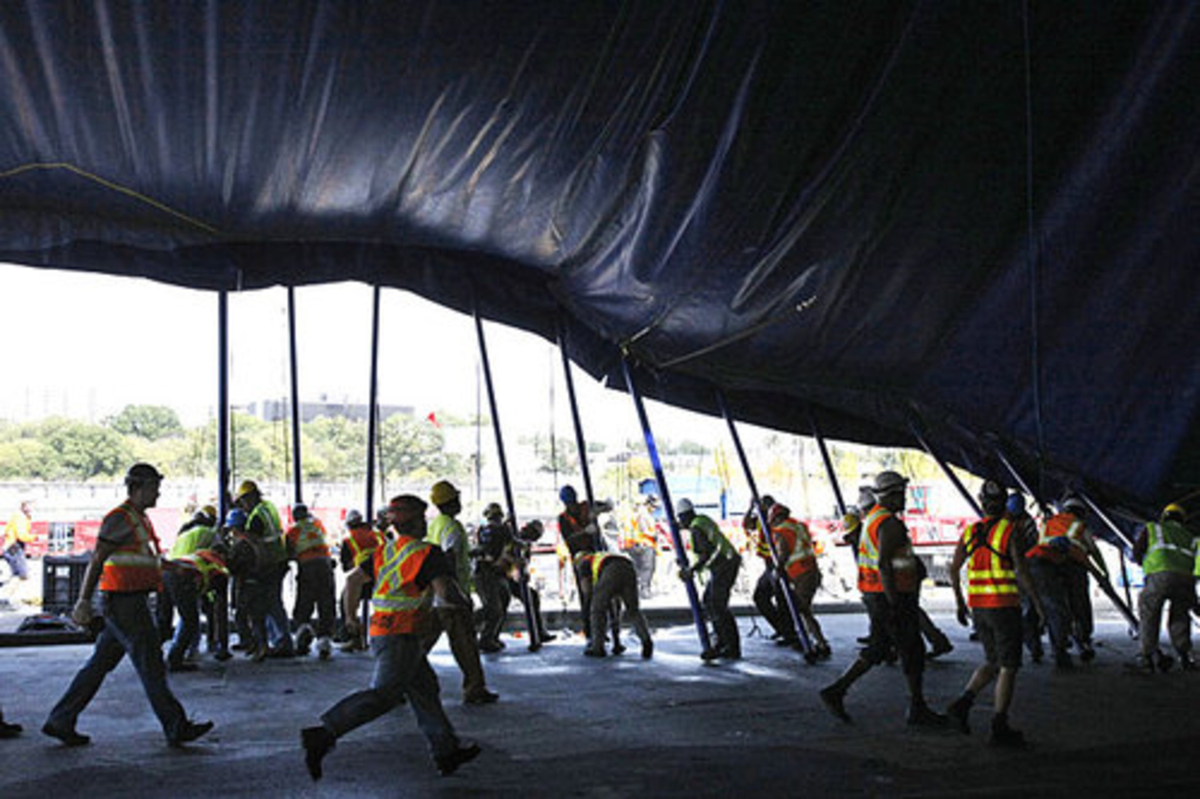 It takes dozens of scrambling workers for "The Big Push" to raise the Grand Chapiteau (Big Top) of the Cirque du Soleil Village in Atlanta on Thursday, Oct. 28.