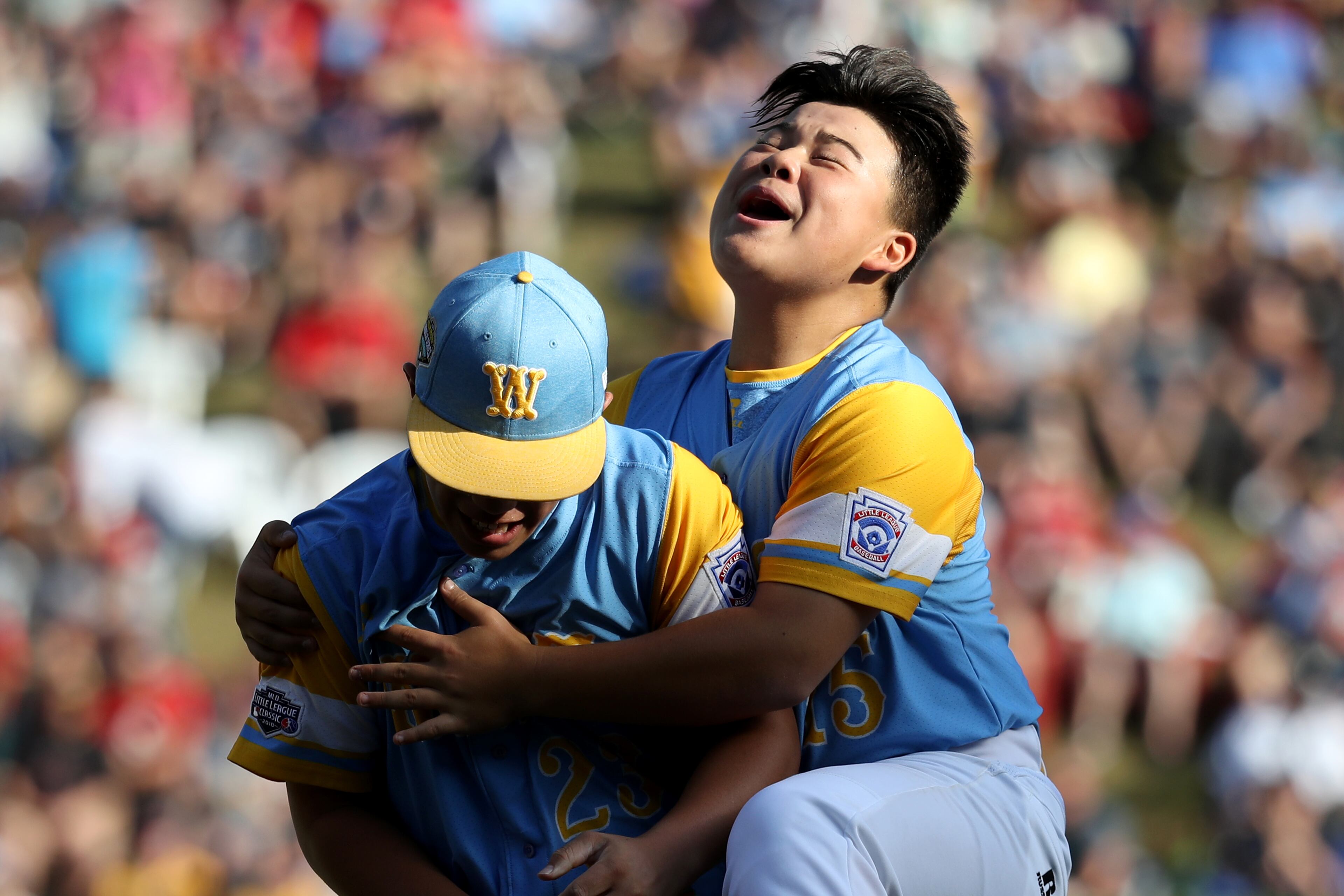SOUTH WILLIAMSPORT, PA - AUGUST 25: Starting pitcher Aukai Kea #23 (L) of the West Region from Hawaii celebrates getting the final out with teammate Sean Yamaguchi #15 during their 3-0 win over the Southeast Team of Georgia during the U.S. Championship game of the Little League World Series at Lamade Stadium on August 25, 2018 in South Williamsport, Pennsylvania. (Photo by Rob Carr/Getty Images)