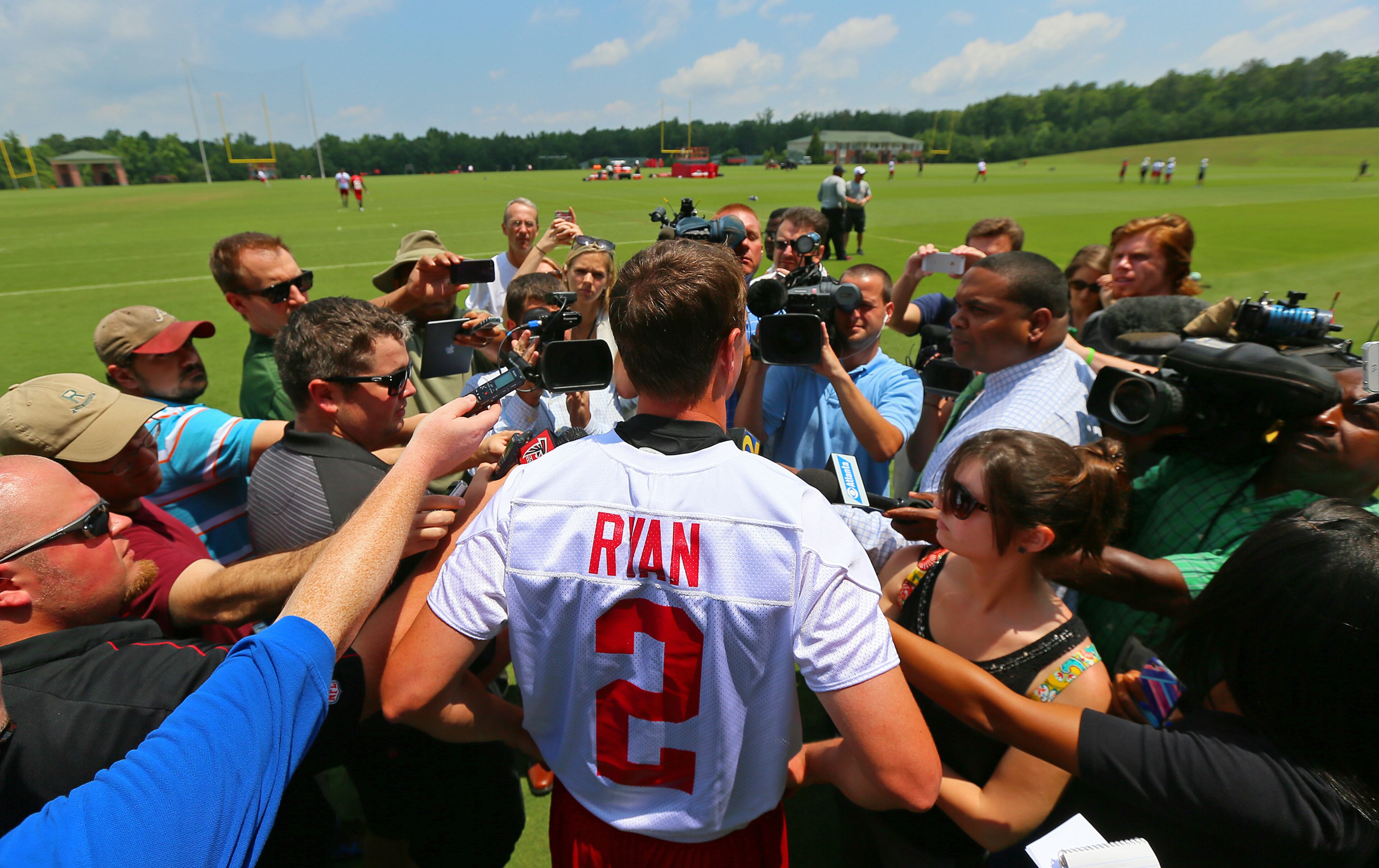 Falcons quarterback Matt Ryan is surrounded by the media for his on field press conference after practice. CURTIS COMPTON / CCOMPTON@AJC.COM