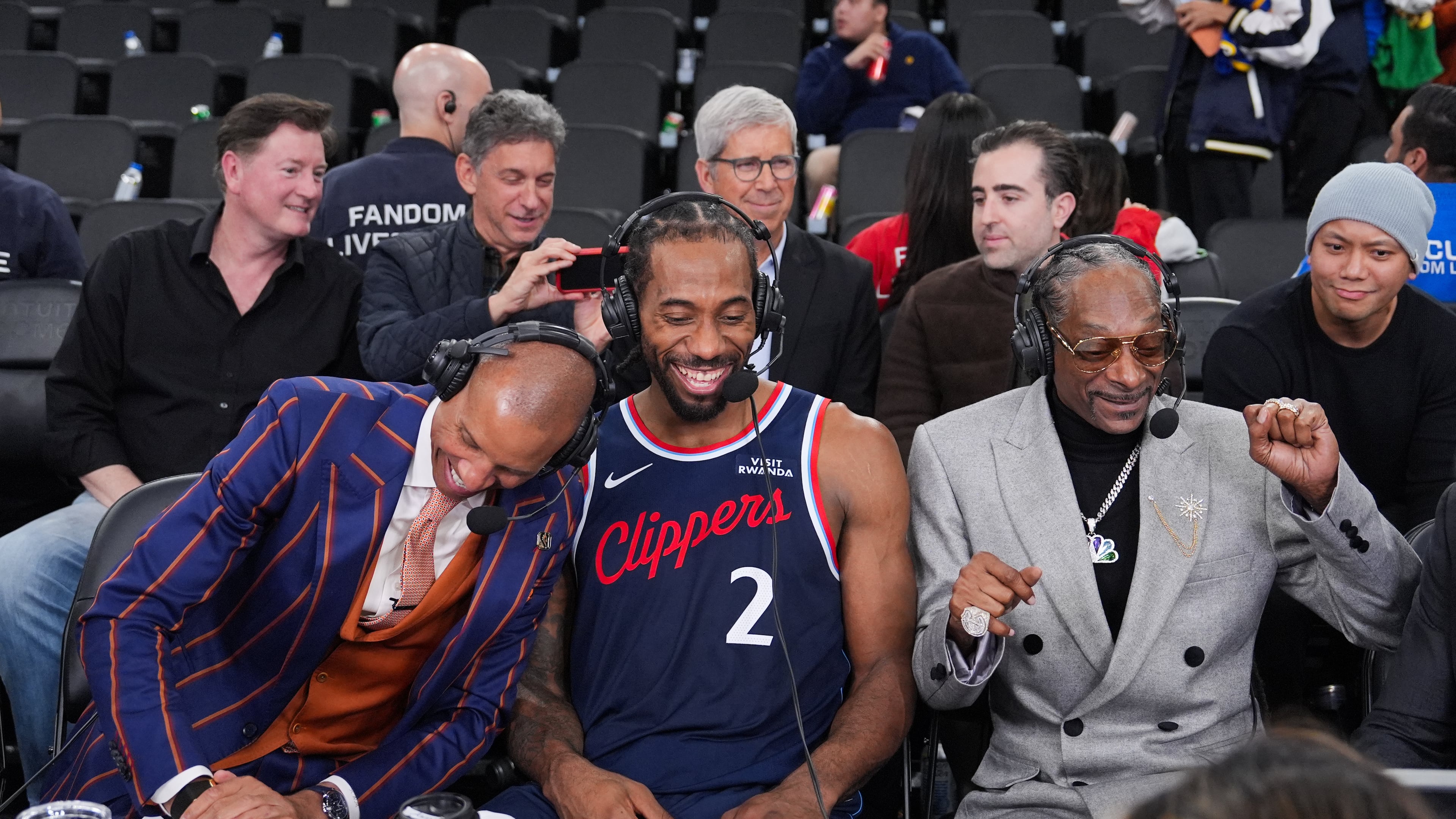 NBA analyst, Snoop Dogg, right, appears with Los Angeles Clippers forward Kawhi Leonard, center, and former NBA player and lead game analyst for NBC Sports, Reggie Miller, following the team's NBA basketball game against the Golden State Warriors, Monday, Jan. 5, 2026, in Inglewood, Calif. (AP Photo/Jae C. Hong)
