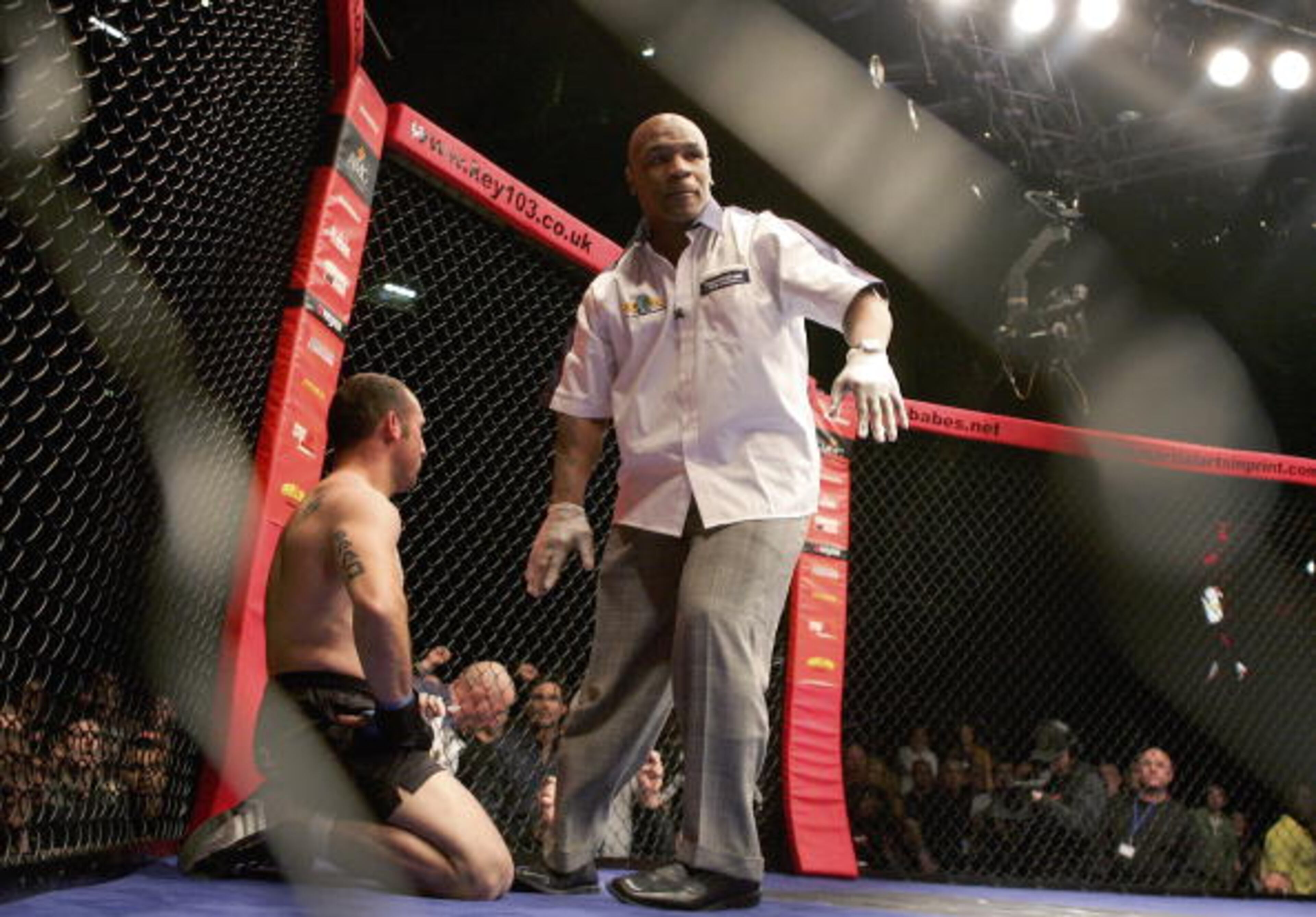 MANCHESTER, UNITED KINGDOM - MARCH 18: Referee Mike Tyson stops the fight between Diego Gonzalez (L) of Spain and Terry Etim of England, declard the winner, during the World Cage Fighting Championships at the MEN Arena on March 18, 2006 in Manchester, England. (Photo by Julian Finney/Getty Images)