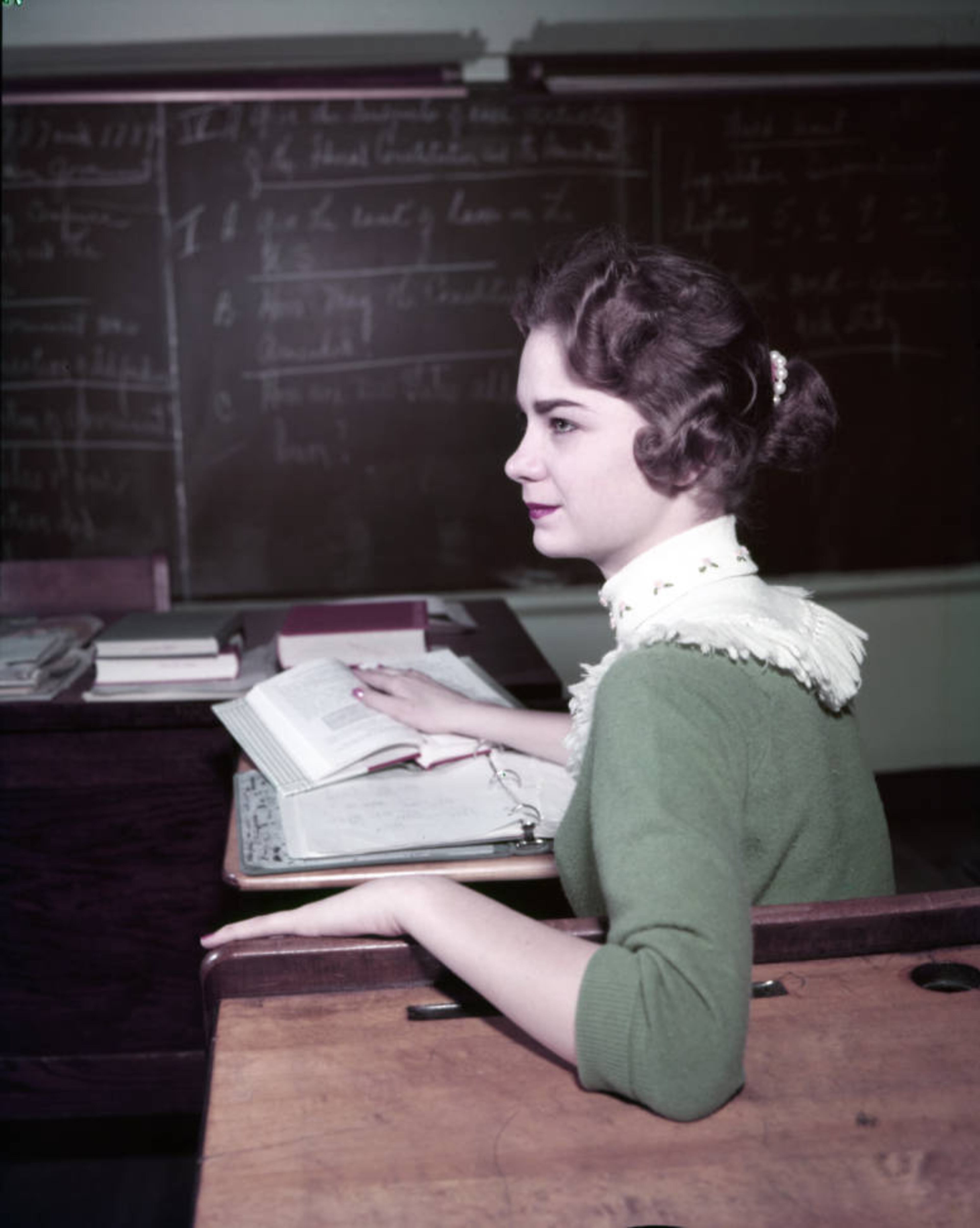 From the original caption info in 1959: "Charlotte Lee wears fringed collar. A pearl clasp holds her ponytail."