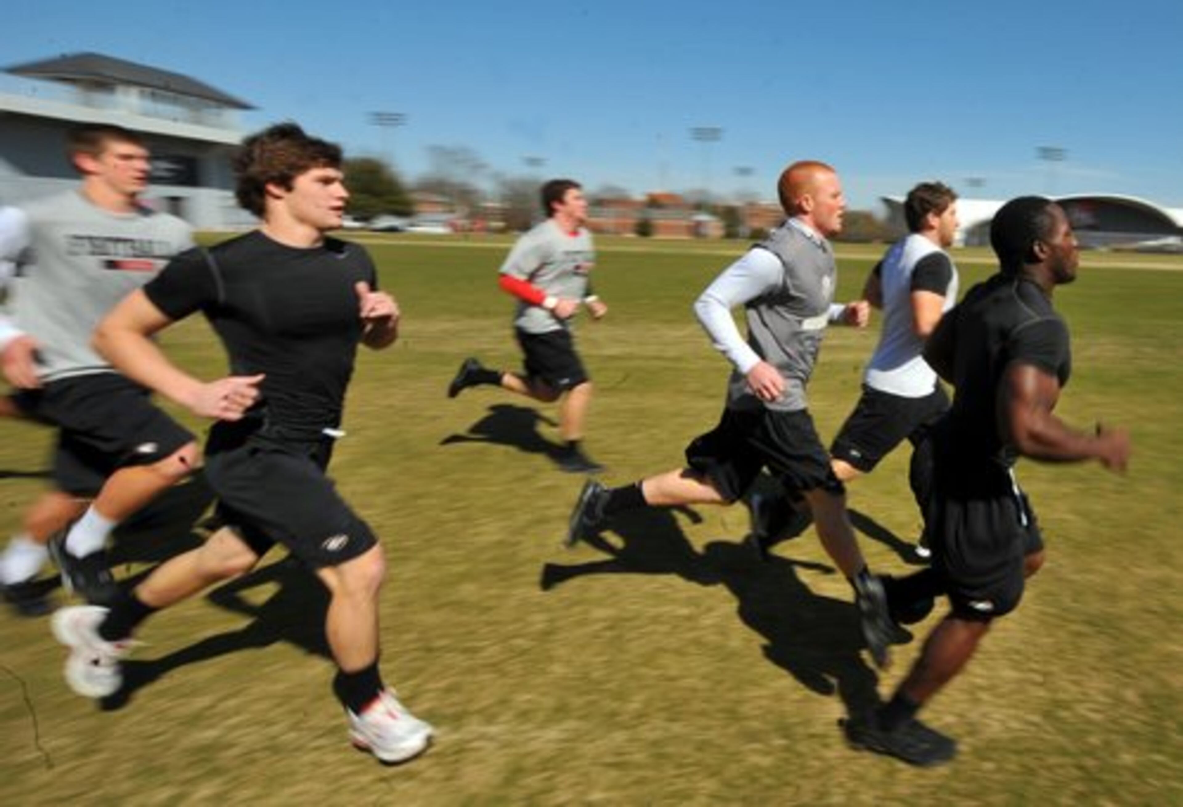 Georgia players cool down after lifting weights with a run on the practice field. The team conditions five days a week as it prepares for spring practices.