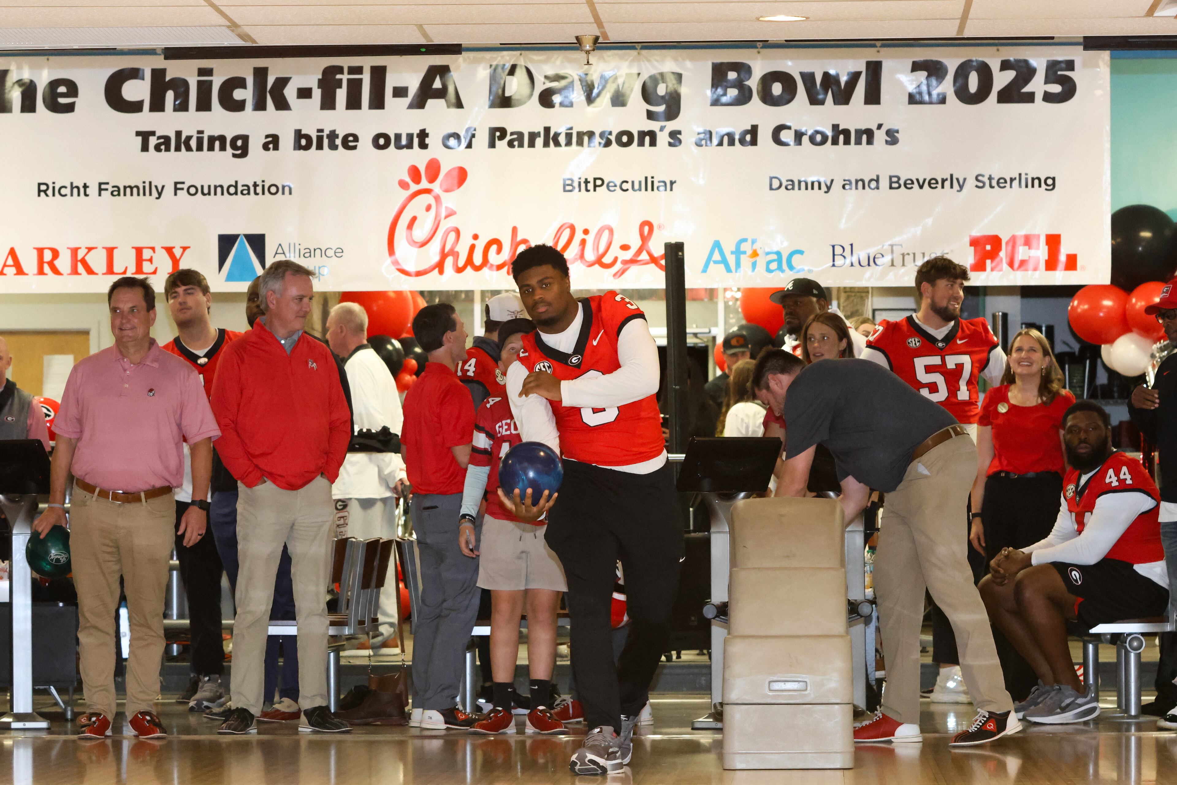 UGA inside linebacker CJ Allen (center) bowls during the third annual Chick-fil-A Dawg Bowl fundraiser for Parkinson’s and Crohn’s disease research at Showtime Bowl in Athens on Wednesday, Oct. 22, 2025. (C.J. Bartunek for the AJC)