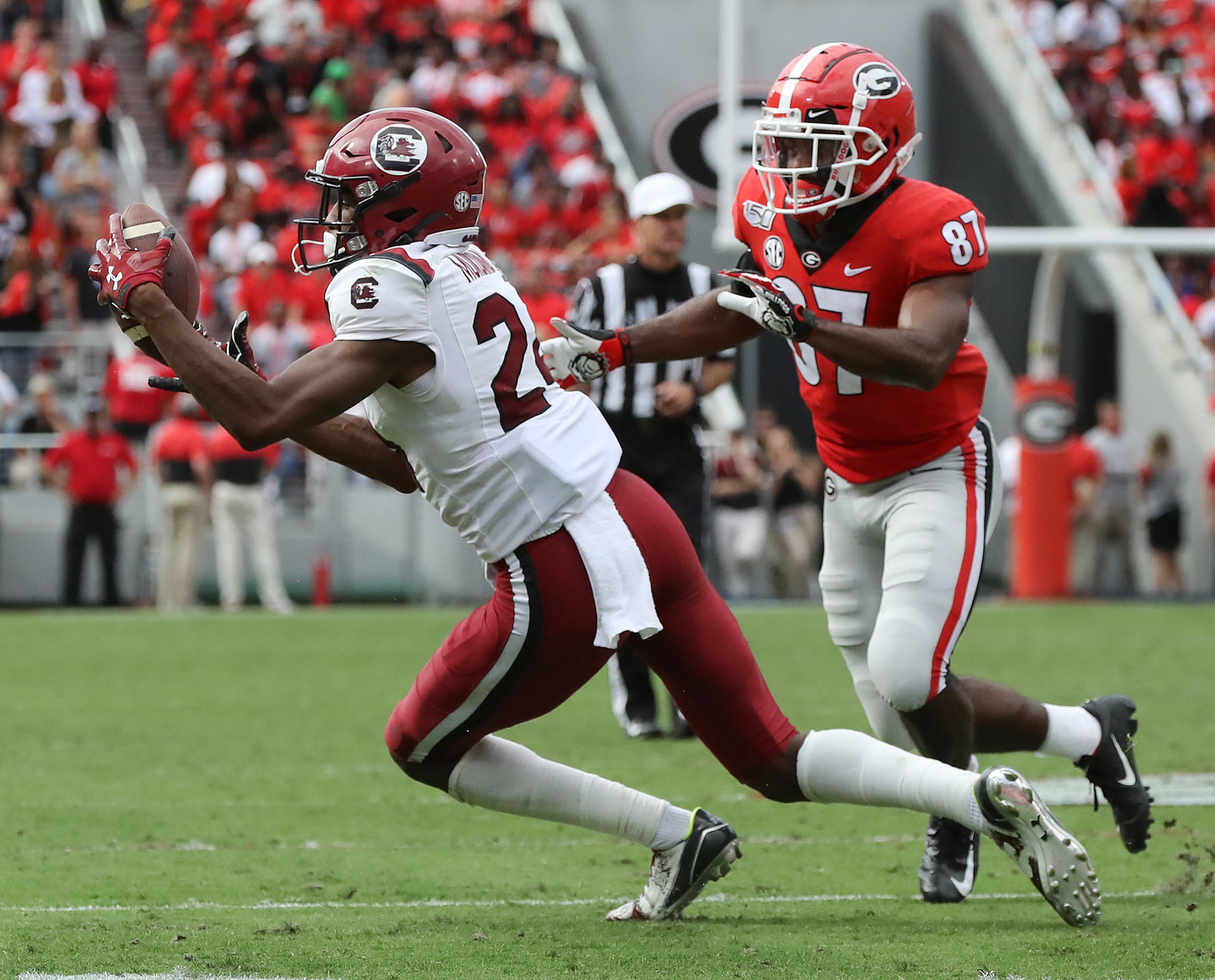 South Carolina defensive back Israel Mukuamu intercepts Georgia quarterback Jake Fromm's pass to wide receiver Tyler Simmons. Curtis Compton/ccompton@ajc.com