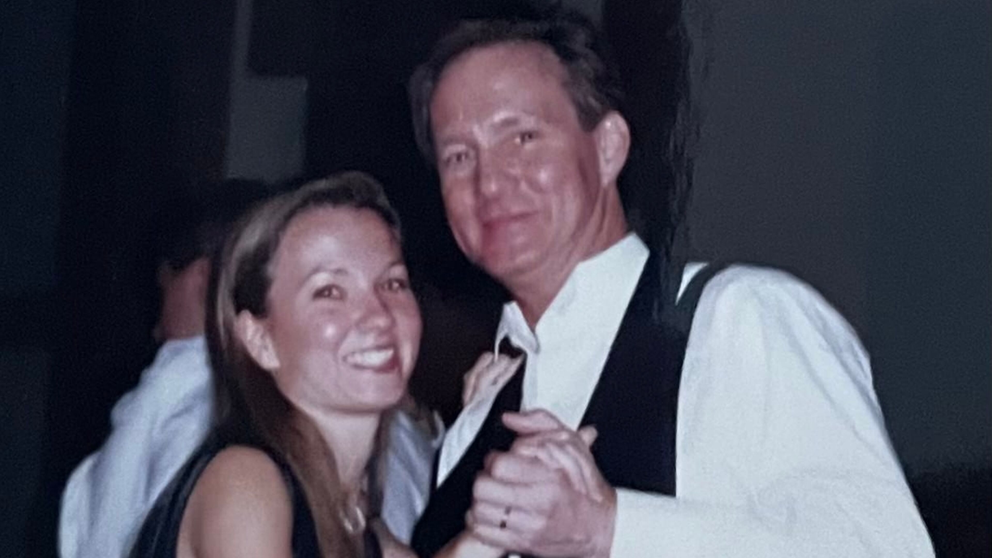 Writer Angela English Hansberger and her dad, Walter English, are seen dancing at a wedding. At her own wedding, they danced to "Sunshine on My Shoulder." Courtesy of Angela Hansberger