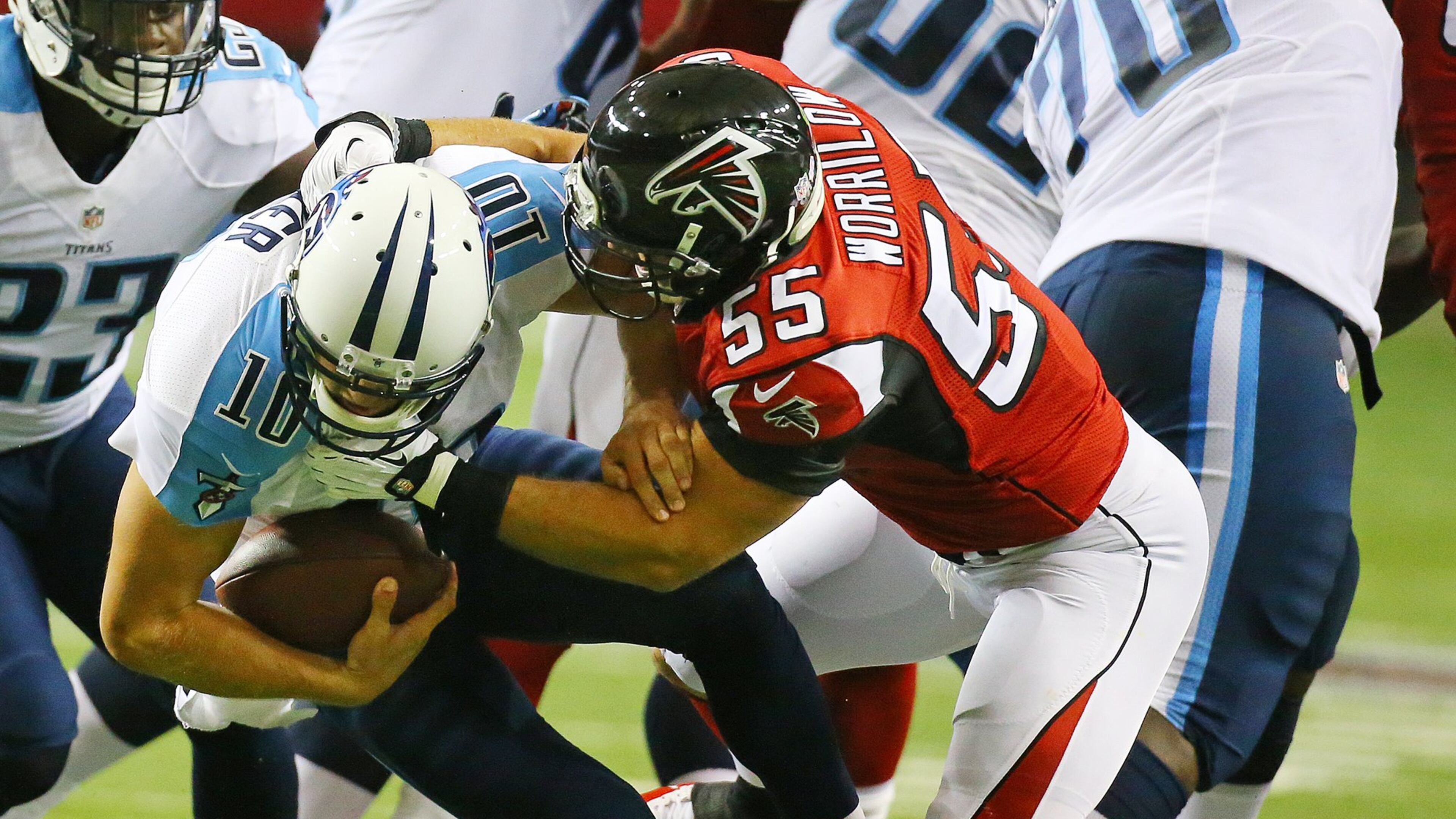 082314 Atlanta: Falcons linebacker Paul Worrilow sacks Titans quarterback Jake Locker during the first quarter in their NFL exhibition game on Sunday, August 23, 2014, in Atlanta. CURTIS COMPTON / CCOMPTON@AJC.COM