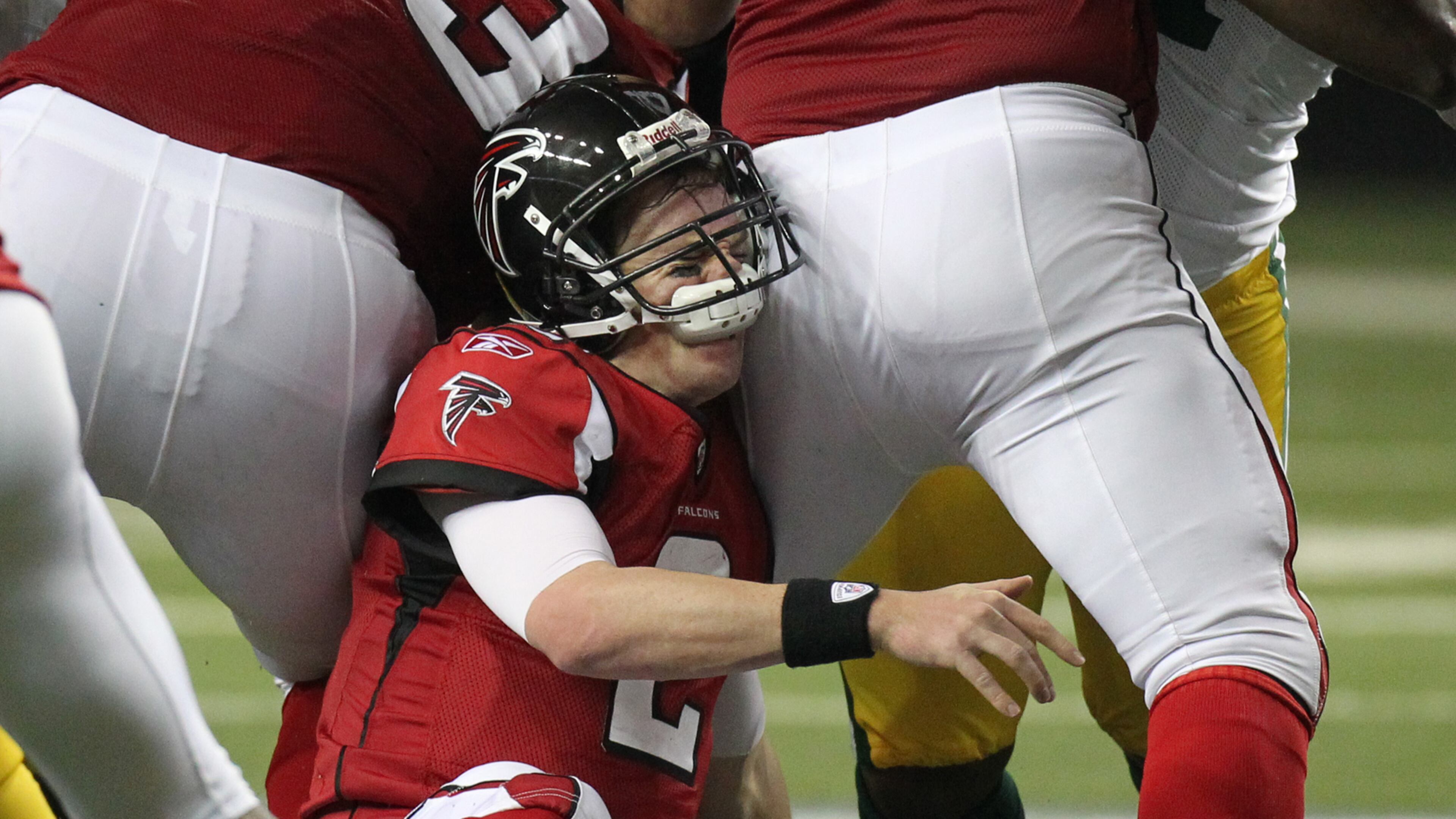 Atlanta Falcons quarterback Matt Ryan eats his face mask as he fumbles the ball on a sack.