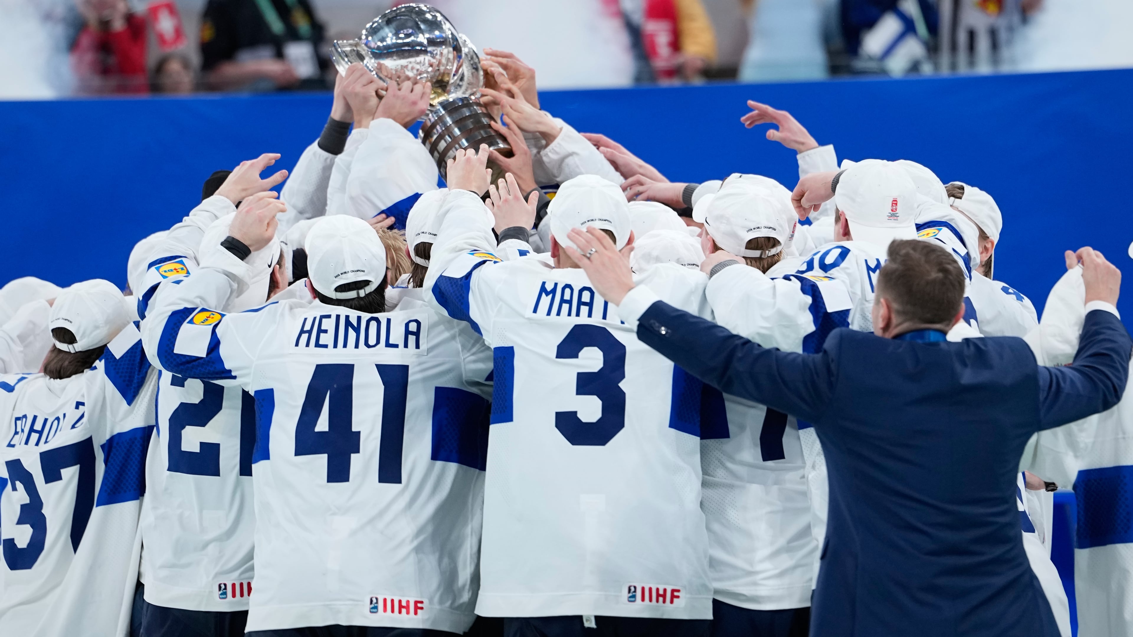 Finland players celebrate with trophy after winning the 2026 IIHF Men's Ice Hockey World Championship final match against Switzerland, in Zurich, Switzerland, Sunday, May 31, 2026. (AP Photo/Darko Bandic)