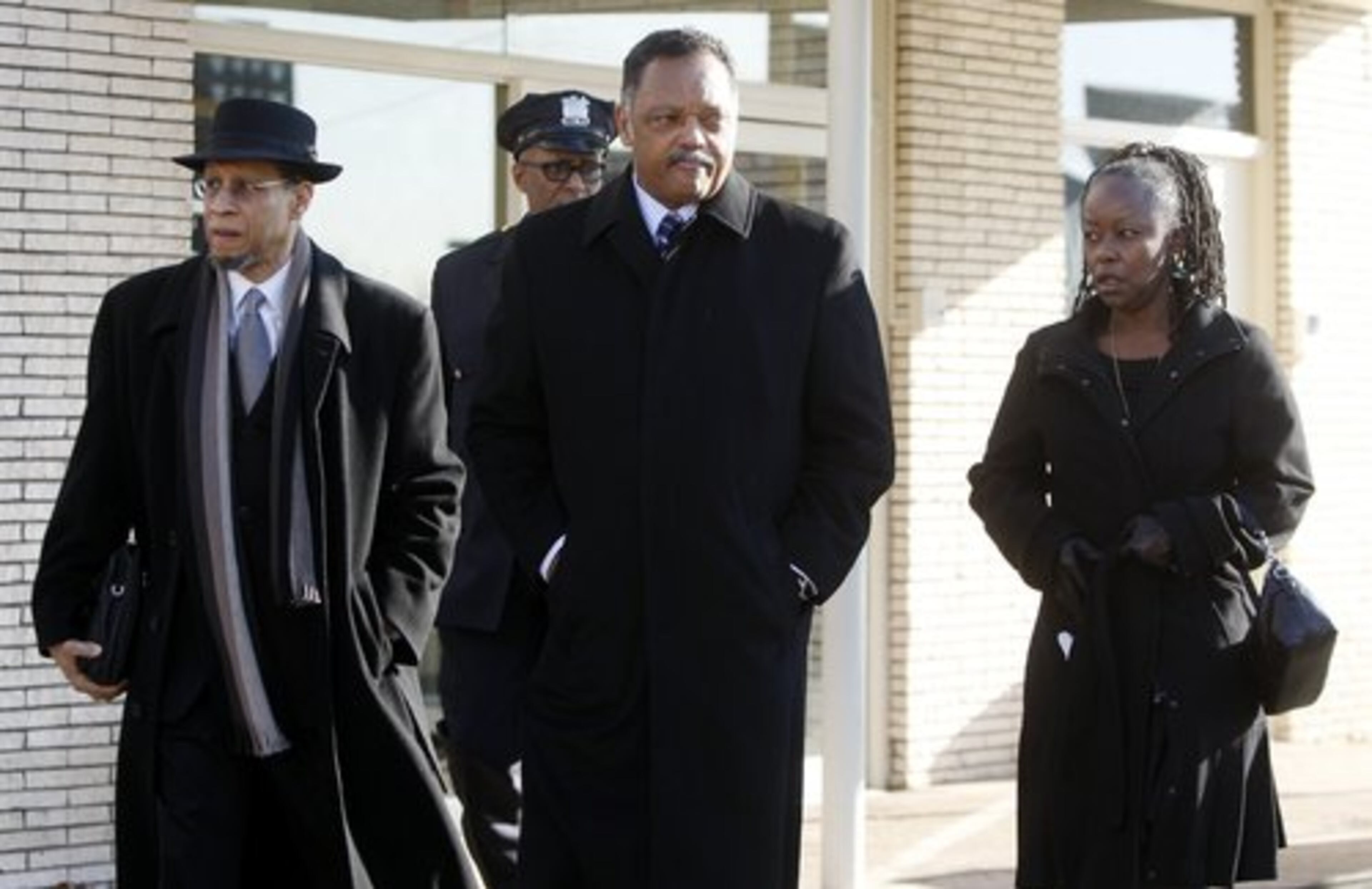 The Rev. Jesse Jackson, center, leaves Whigham Funeral Home after visiting with the family of Whitney Houston before going to the New Hope Baptist Church for her funeral in Newark, N.J. on Saturday, Feb. 18, 2012.