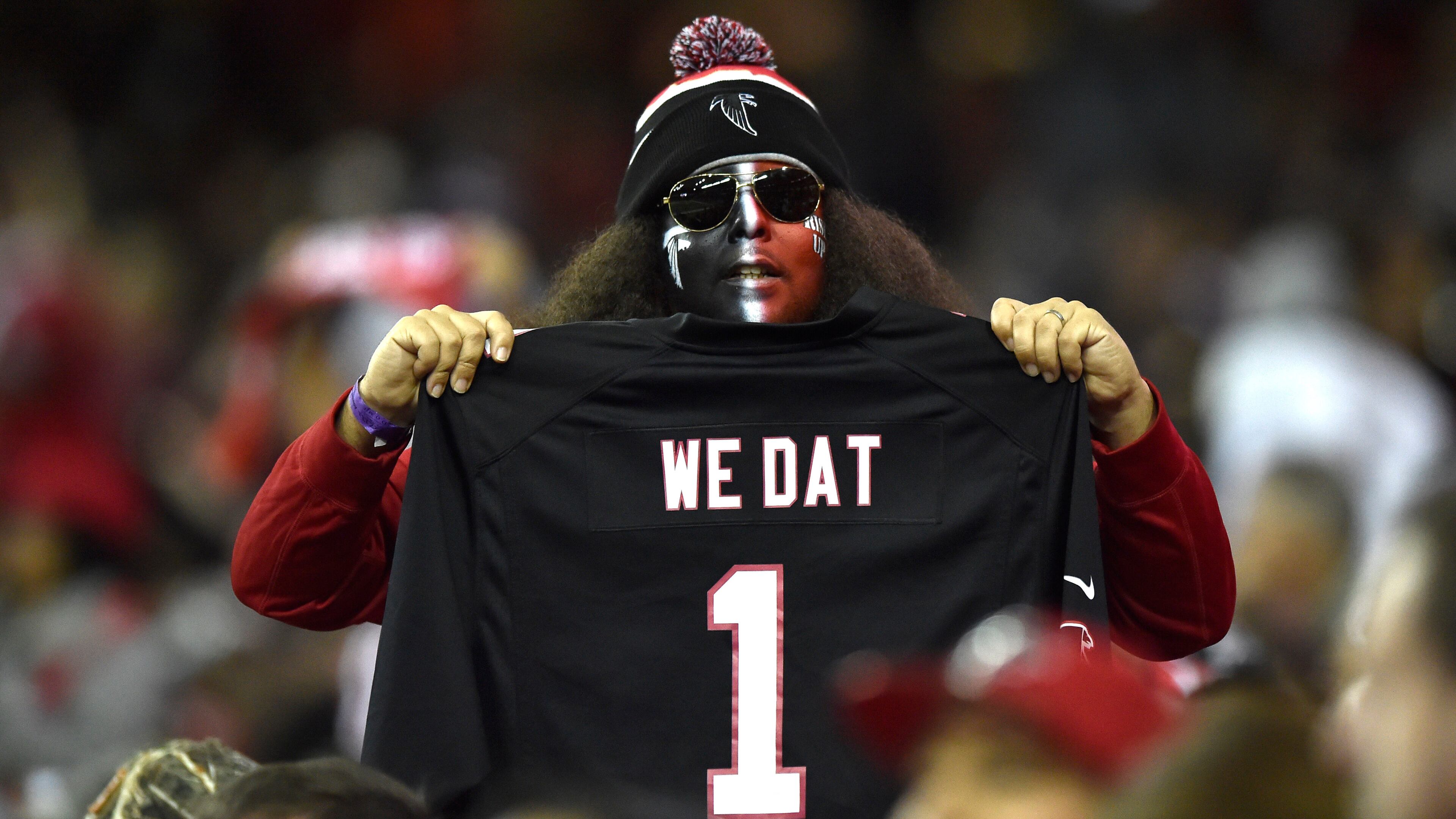 January 1, 2017, Atlanta - A Falcons fan holds a jersey during the NFL football game against the Saints in Atlanta, Georgia, on Sunday, January 1, 2017. (DAVID BARNES / DAVID.BARNES@AJC.COM)