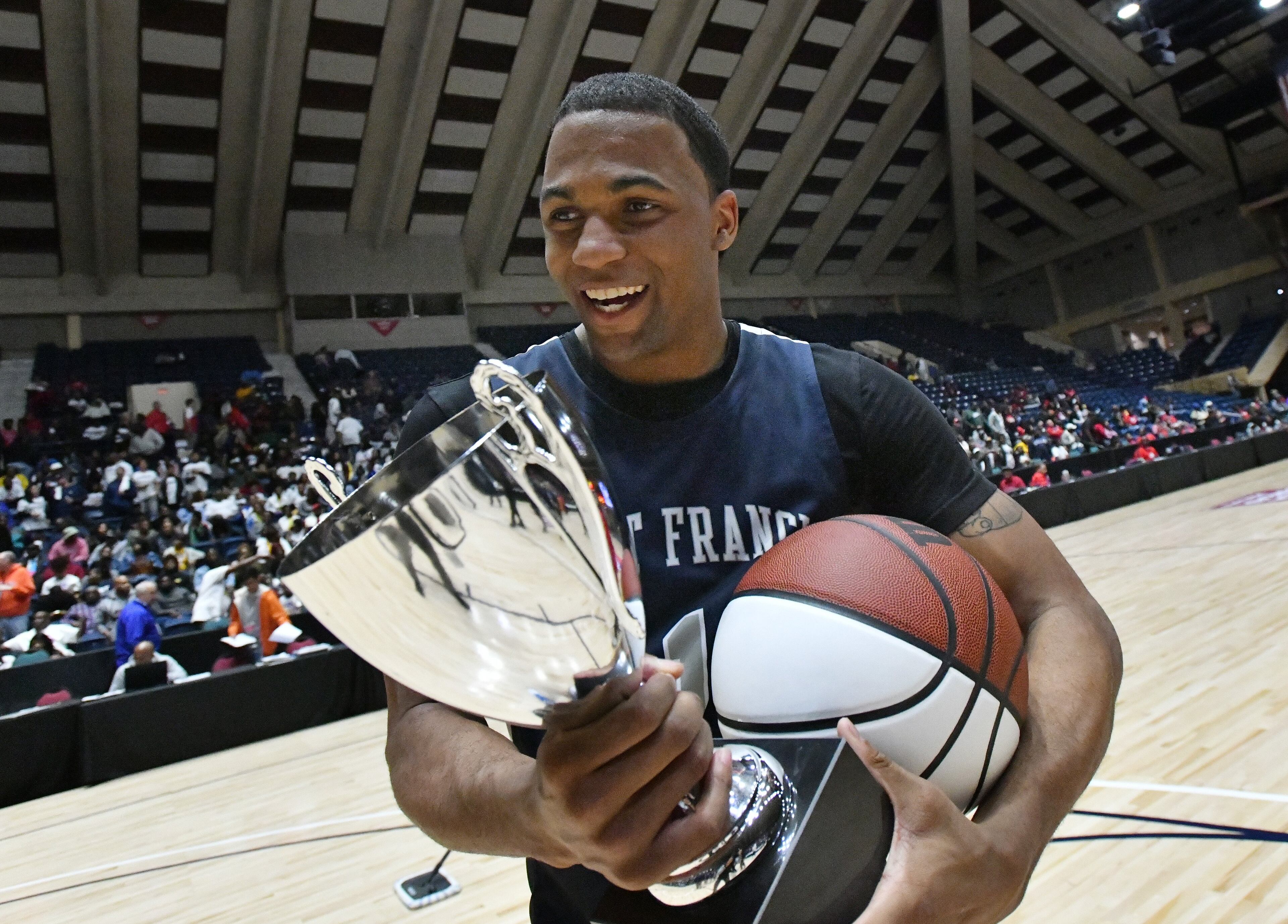 St. Francis' Dwon Odom (1) holds the championship trophy. St. Francis won 76-55 over Greenforest. (Hyosub Shin / Hyosub.Shin@ajc.com)