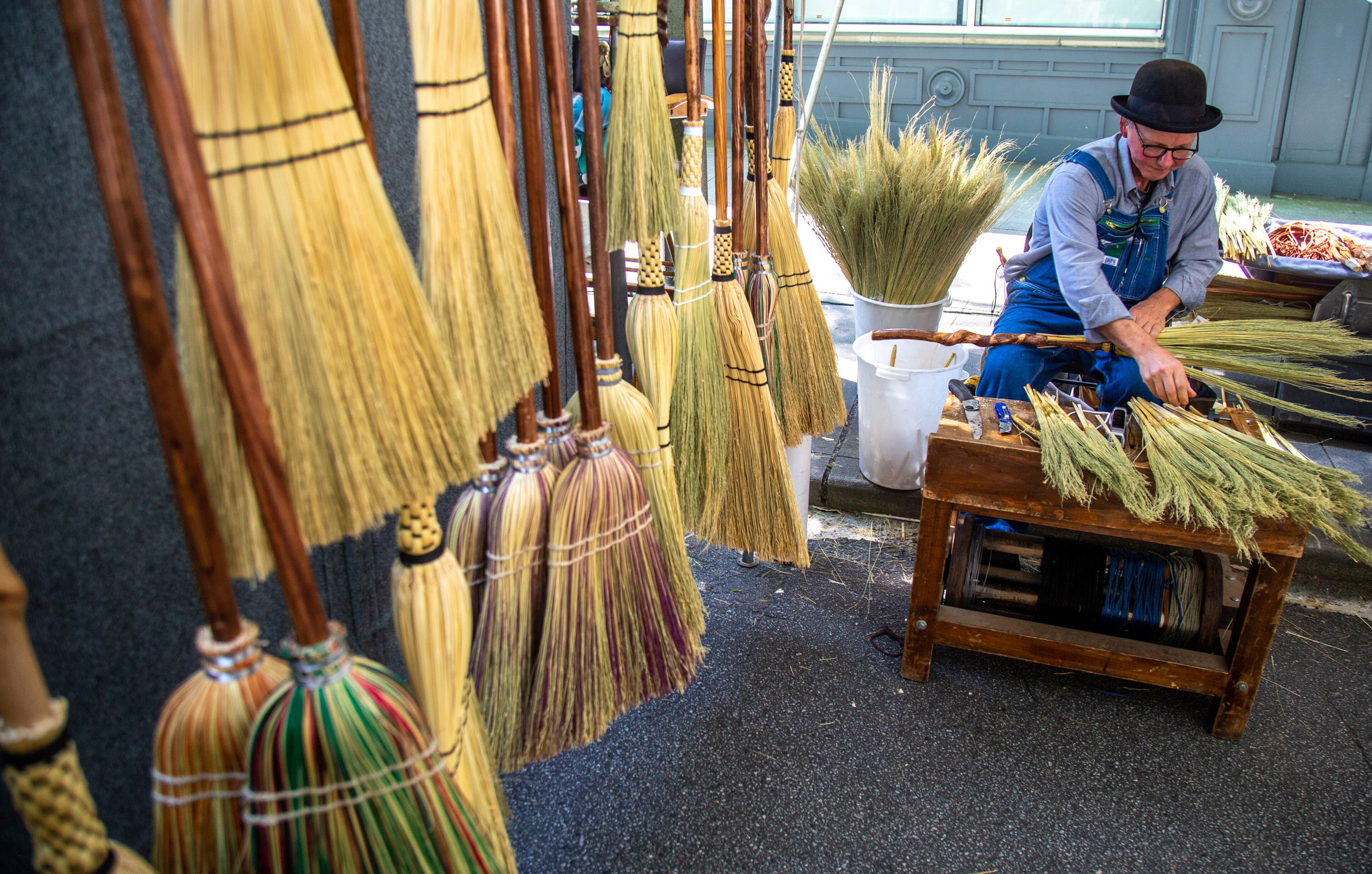 George Jones works on one of his handmade brooms during the annual Decatur Arts Festival on Sunday, May 26, 2019. STEVE SCHAEFER / SPECIAL TO THE AJC