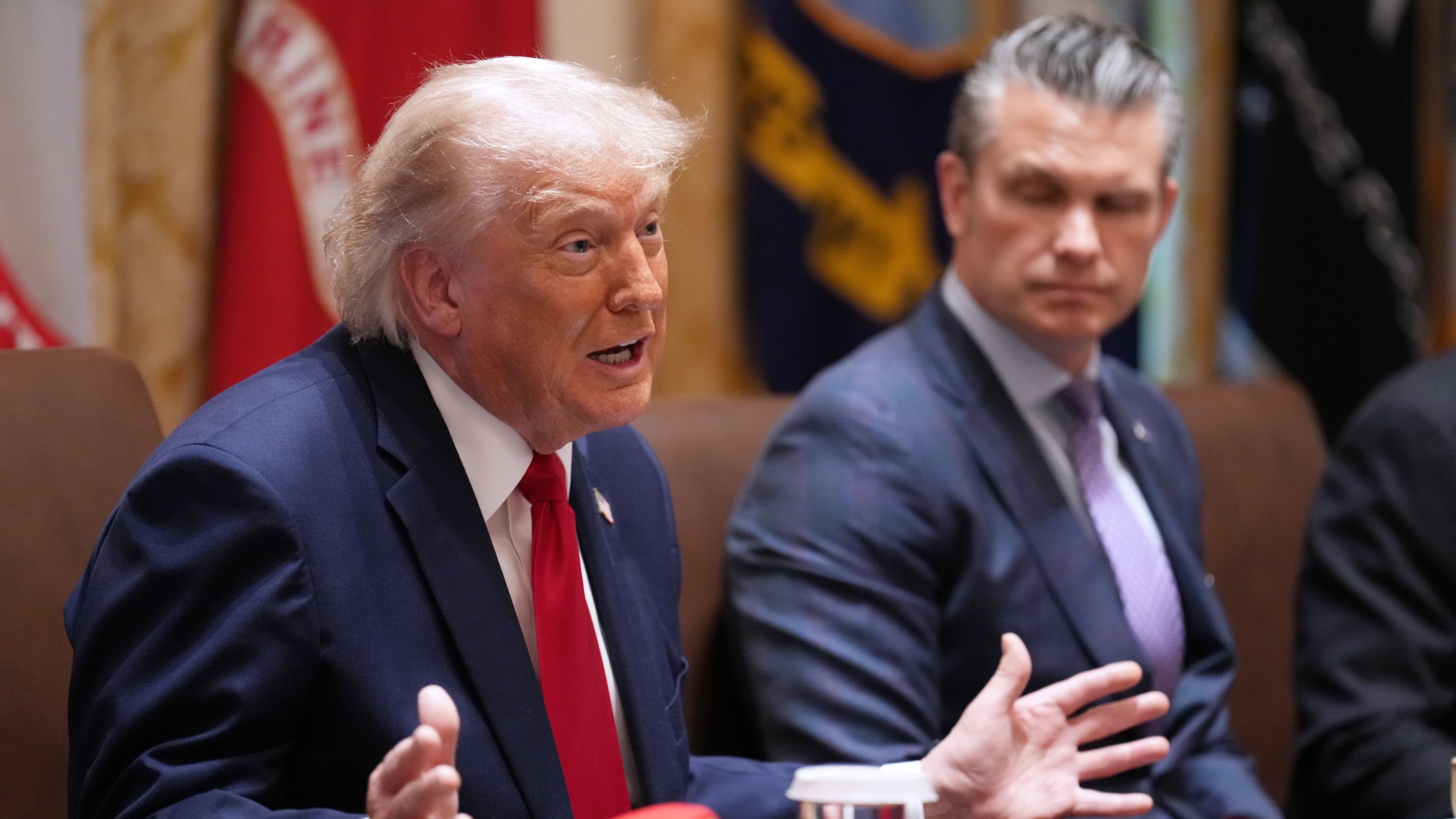 President Donald Trump speaks during a Cabinet meeting at the White House, Wednesday, May 27, 2026, in Washington, as Secretary of Defense Pete Hegseth, looks on. (AP Photo/Jacquelyn Martin)