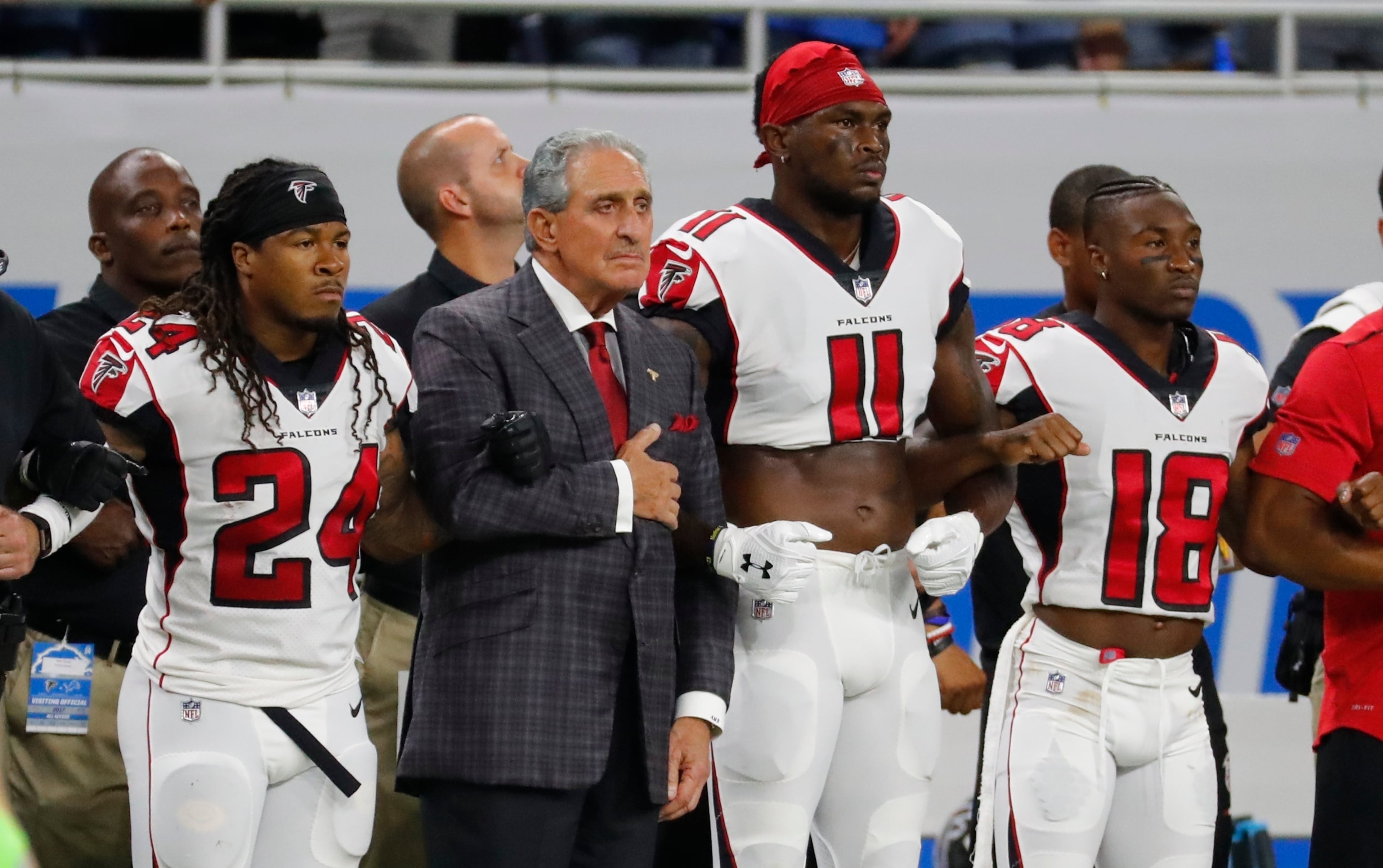 Atlanta Falcons owner Arthur Blank stands with his players during the national anthem before an NFL football game against the Detroit Lions, on Sunday, Sept. 24, 2017, in Detroit. (Rick Osentoski/AP 2017)