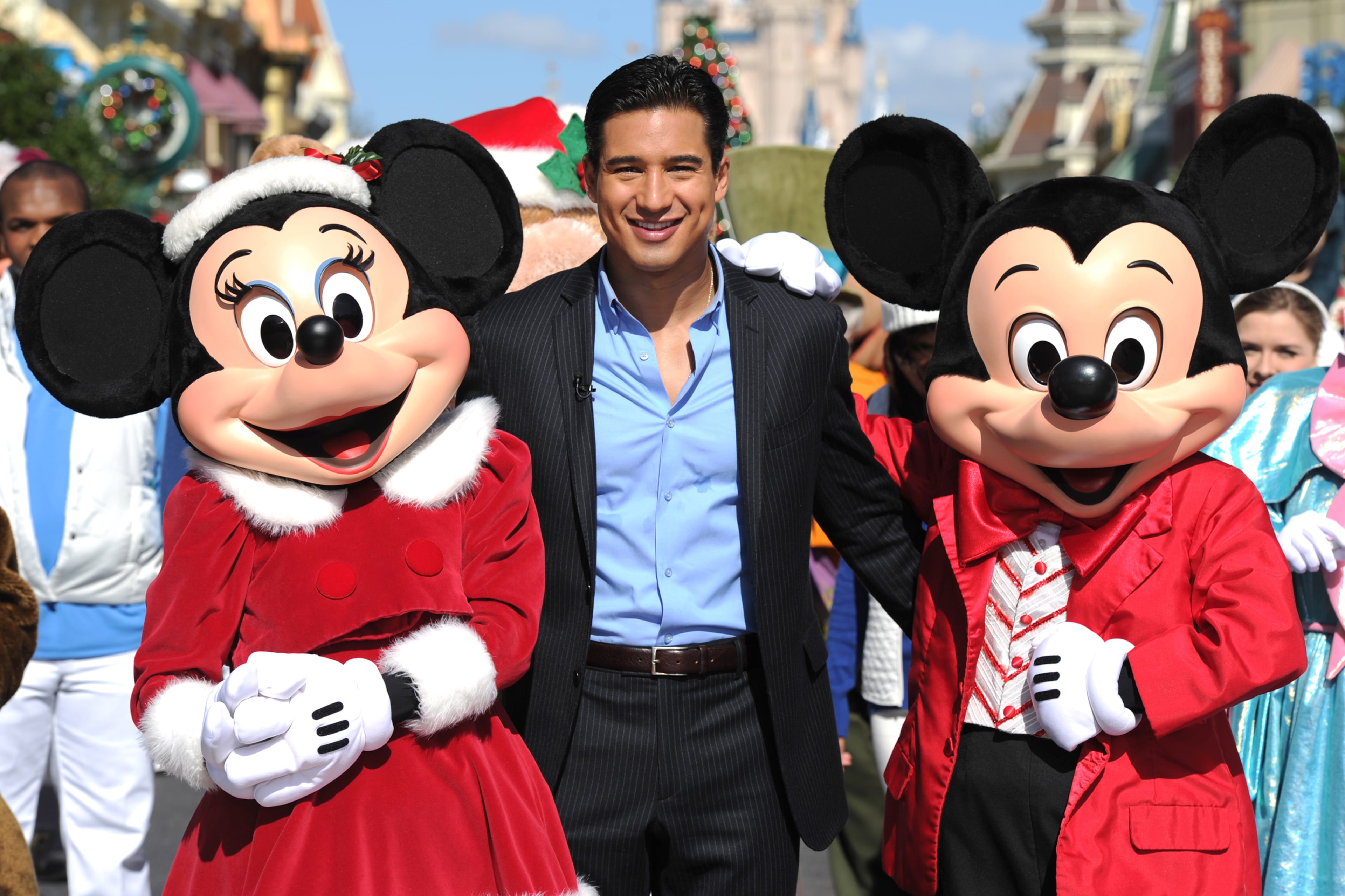 LAKE BUENA VISTA, CA - DECEMBER 03: In this handout photo provided by Disney Parks, TV personality and actor Mario Lopez poses with Mickey Mouse and Minnie Mouse while taping a segment of the "Disney Parks Christmas Day Parade" TV special at the Magic Kingdom park on December 3, 2011 in Lake Buena Vista, Florida. Lopez is one of the hosts of the 28th annual "Disney Parks Christmas Day Parade" that airs nationwide December 25, 2011 on ABC-TV. The holiday telecast features performances by a variety of stars from both Disneyland Resort in California and Walt Disney World Resort in Florida. (Photo by Mark Ashman/Disney Parks via Getty Images)