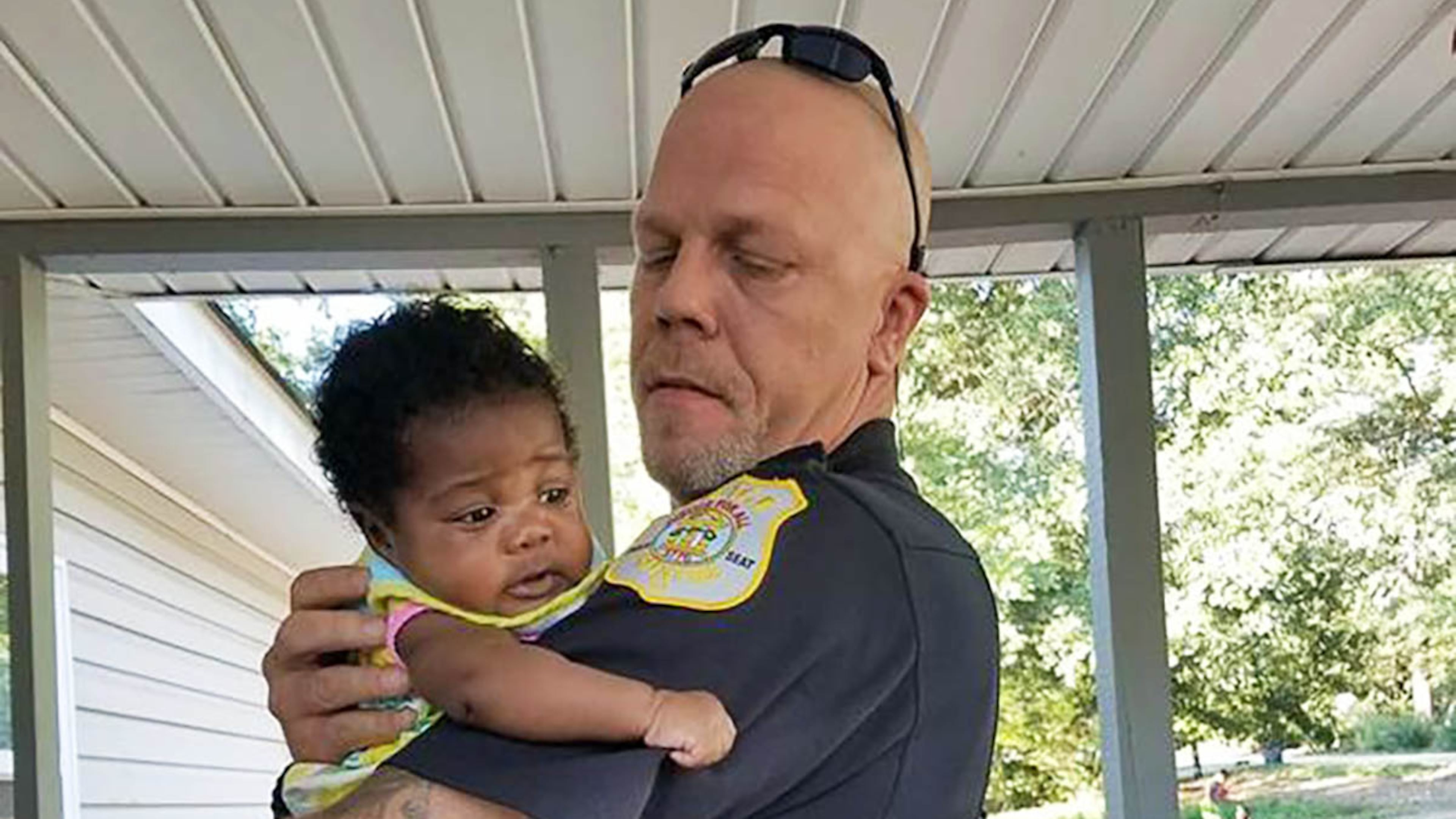 Lt. Kenneth Knox of Meriwether County, Georgia, with his new goddaughter, Ma'Yavi Parham.