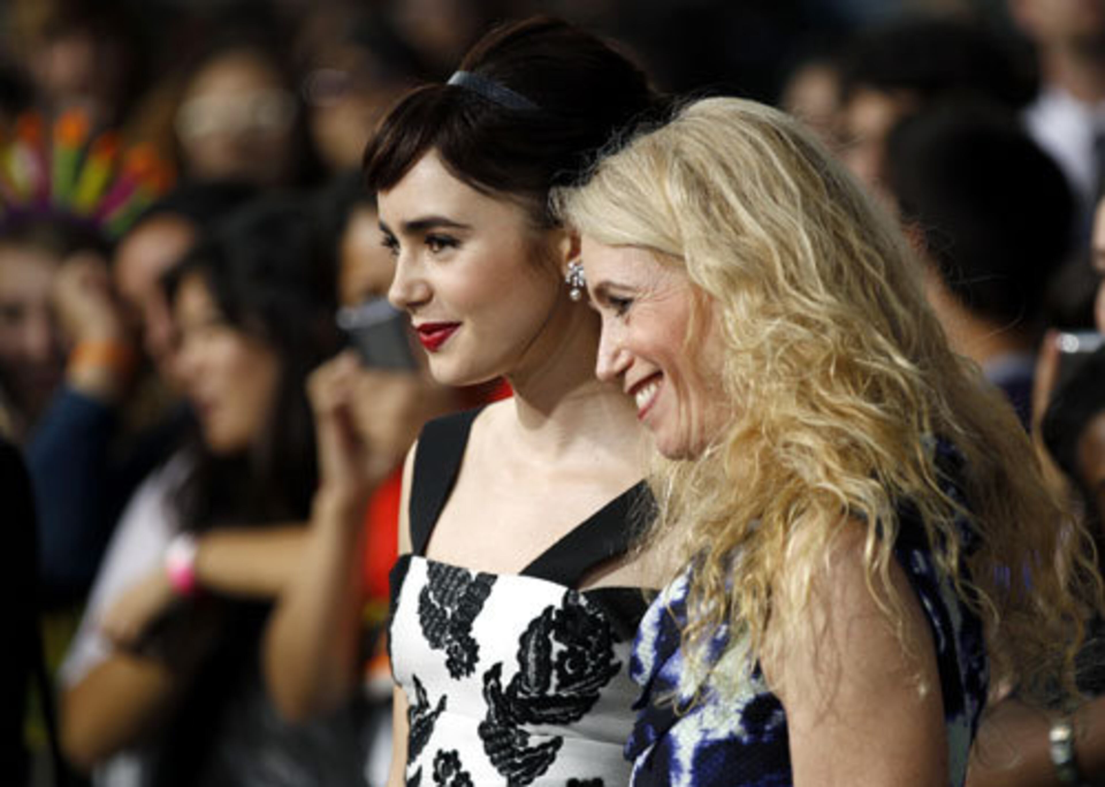 Lily Collins, left, poses on the red carpet with her date to the premiere -- her mother, Jill Tavelman.