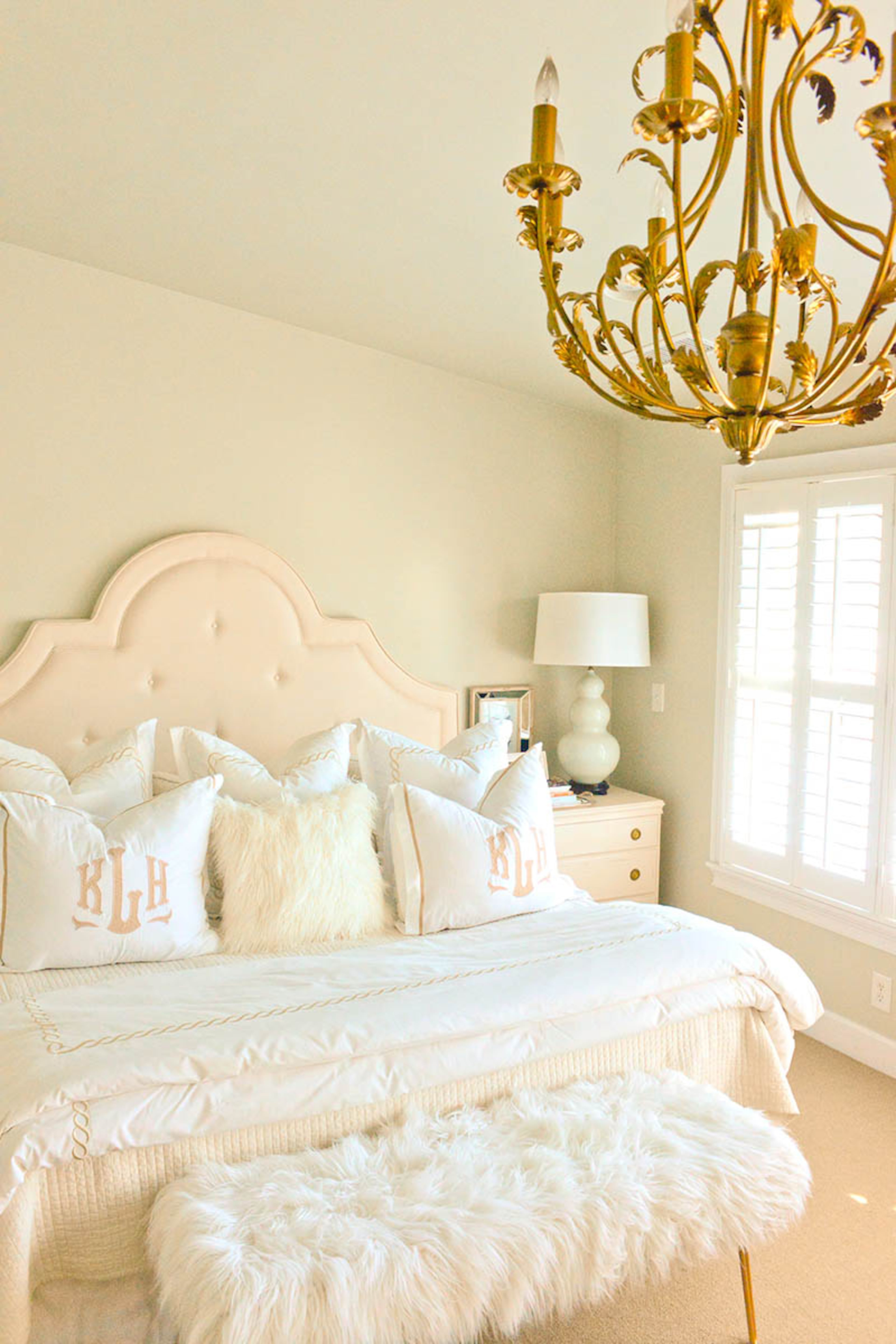 Plush bedding and the soft walls, painted Benjamin Moore Par Four, make the master bedroom a retreat. "Despite it also being the place of my home office, I really feel relaxed in there, and it is my place to escape," said Katie Luepke, who is a pharmacist. The chandelier, which Katie found at a flea market and spruced up with gold paint, adds contrast and style.