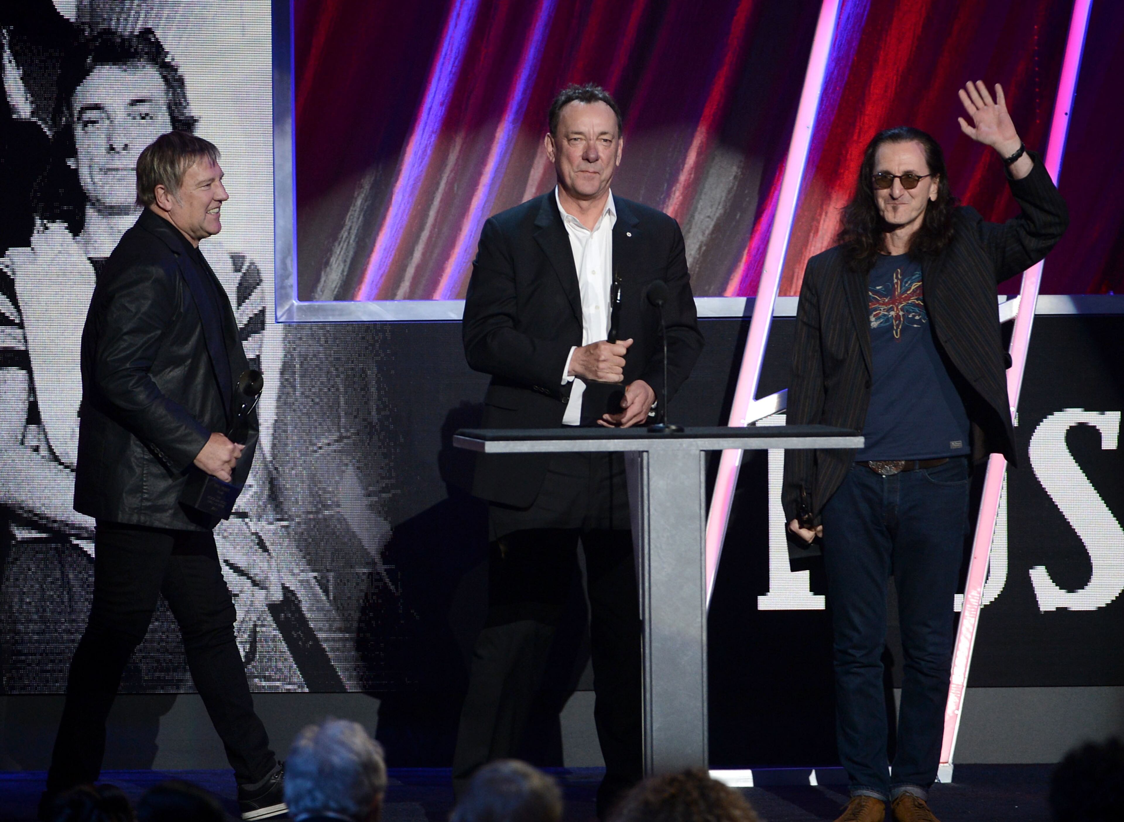 (L-R) Inductees Alex Lifeson, Neil Peart and Geddy Lee of Rush speak onstage at the 28th Annual Rock and Roll Hall of Fame Induction Ceremony at Nokia Theatre L.A. Live on April 18, 2013 in Los Angeles, California. (Photo by Kevin Winter/Getty Images)