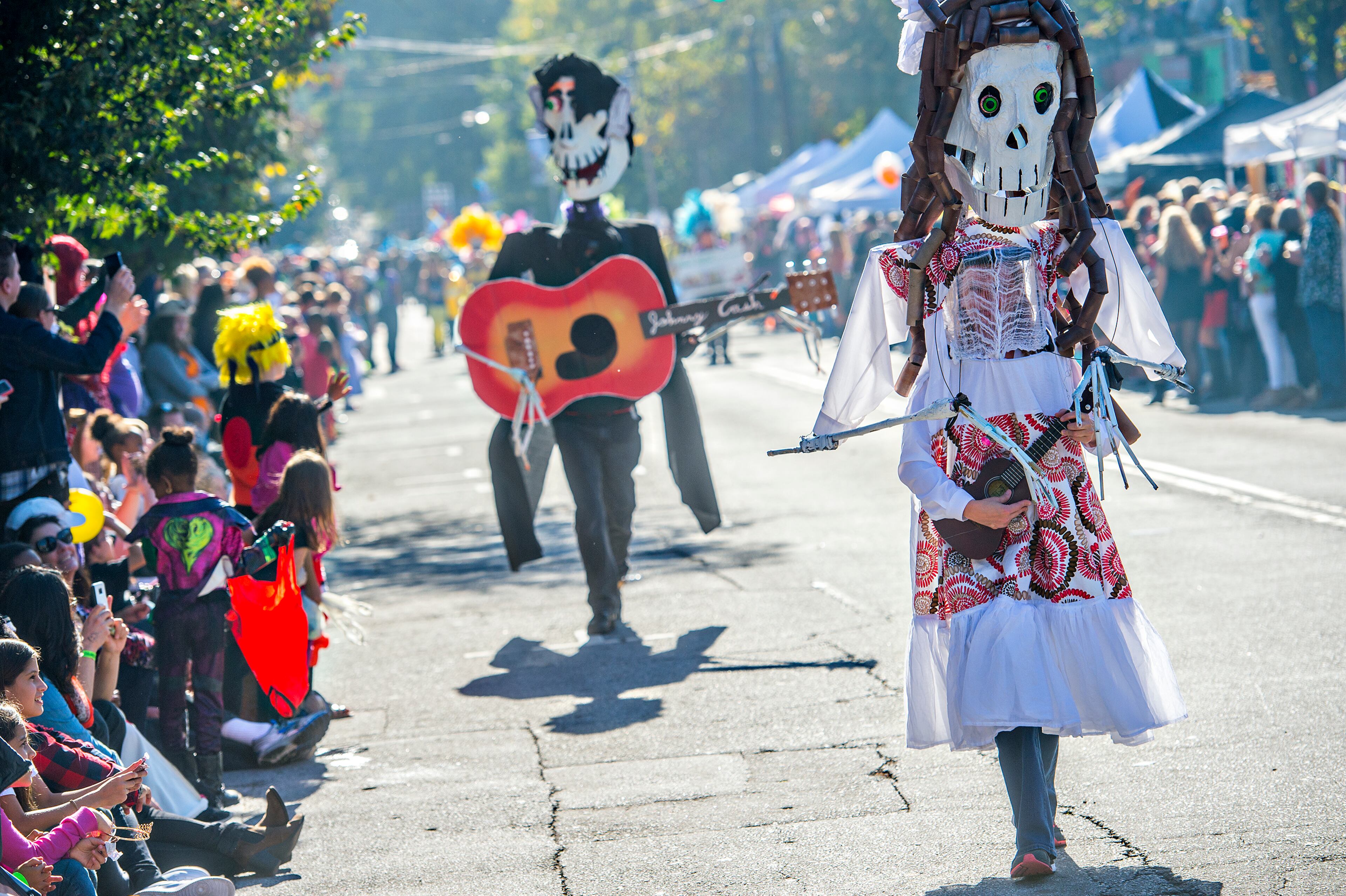 October 17, 2015 Atlanta - Sandy Nichols (right) plays the guitar as she walks up the street during the Little Five Points Halloween Parade in Atlanta on Saturday, October 17, 2015. The annual parade brought out tens of thousands of people to watch the antics. JONATHAN PHILLIPS / SPECIAL