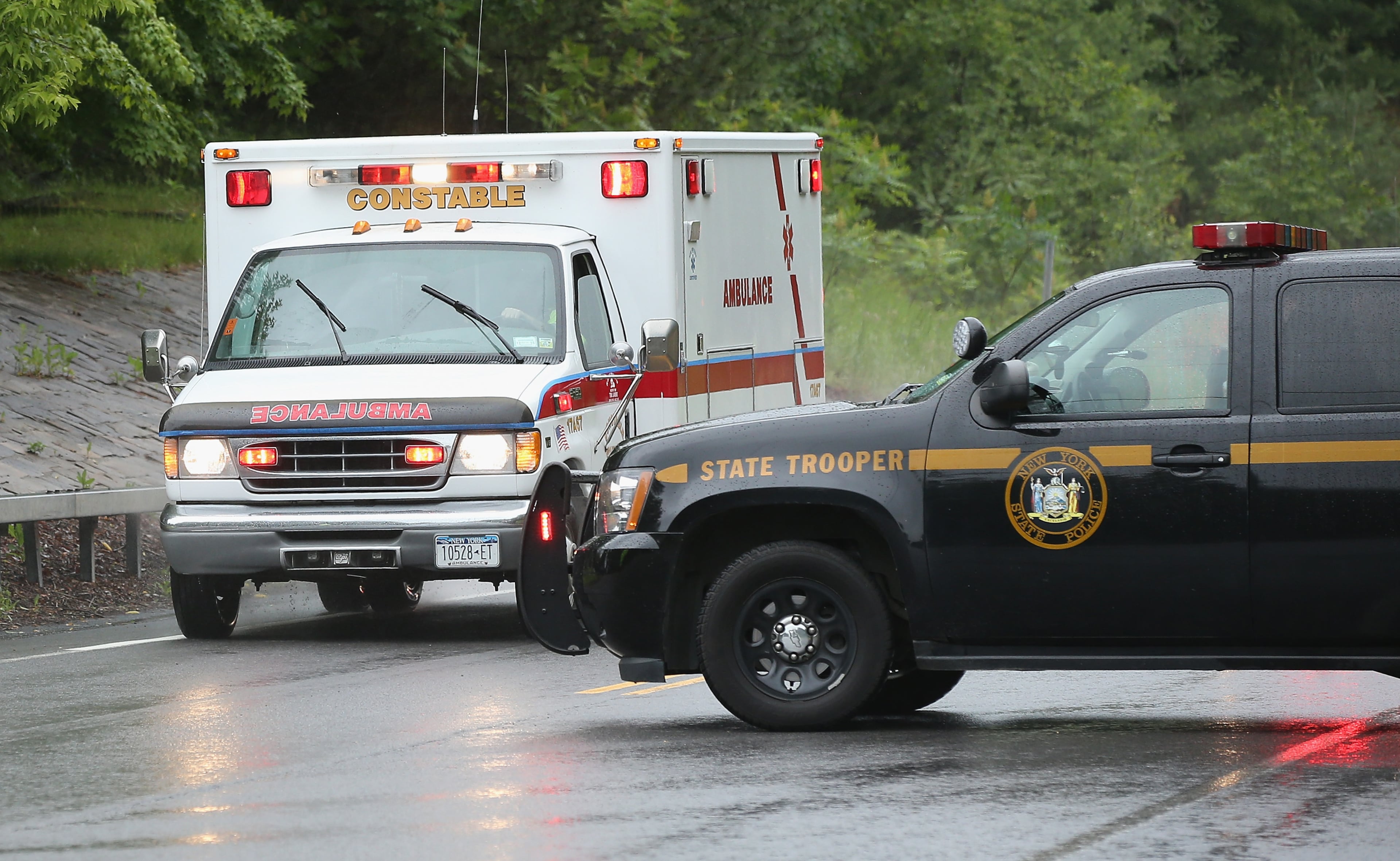 An ambulance, believed to be transporting convicted murderer David Sweat is escorted by N.Y. State Police to Alice Hyde Medical Center on June 28, 2015 in Constable, New York. Escaped inmate David Sweat has been shot by law enforcement and was put in custody in Constable, NY, north of Malone and near the Canadian border. On Friday Richard Matt, who escaped with Sweat, was shot and killed in the same area. More than 1,000 State Police, Border Patrol, correction officers, FBI and other law enforcement agencies have been searching for the pair since they were discovered missing from a prison in nearby Dannemora on June 6. (Photo by Scott Olson/Getty Images)