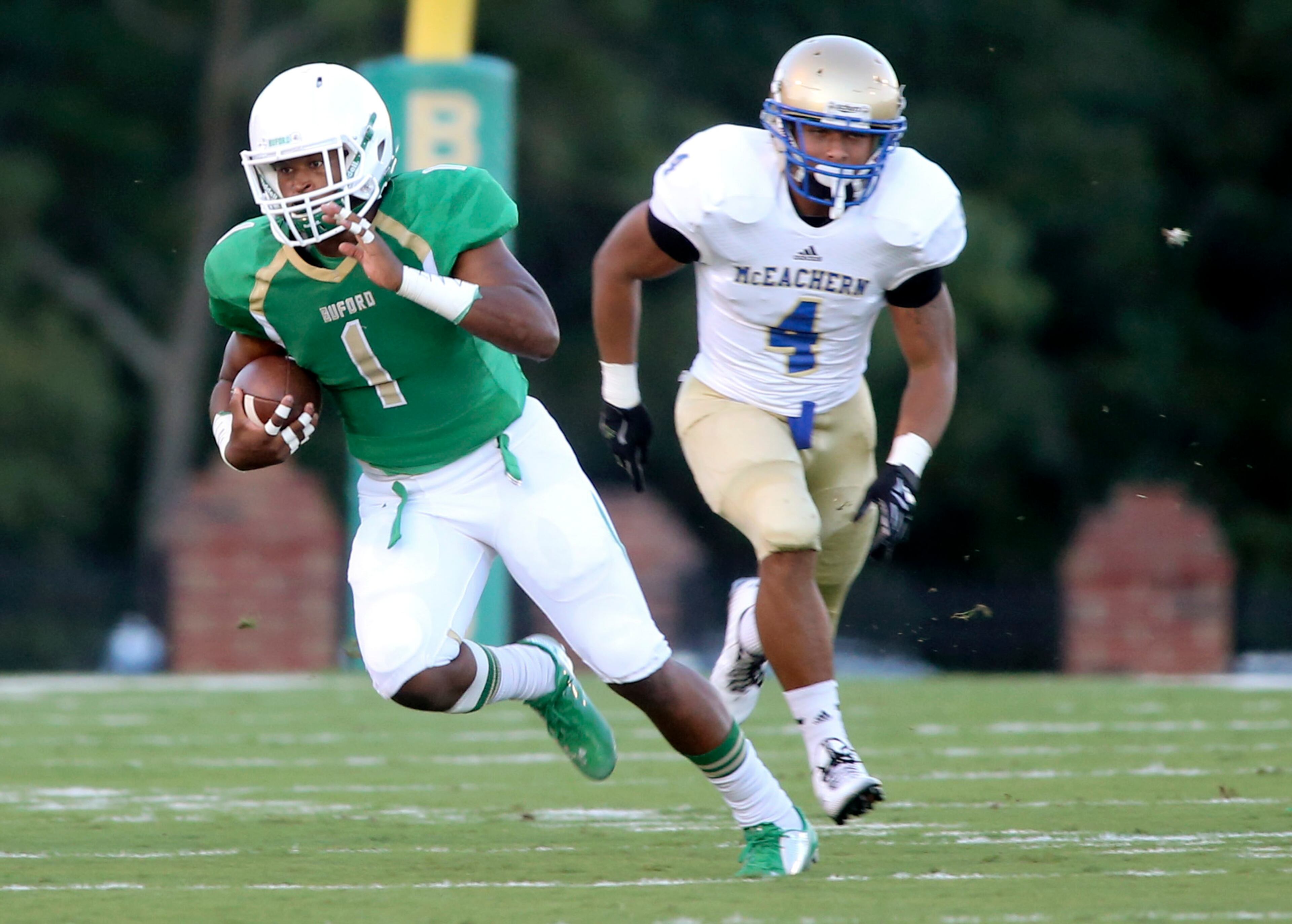 Buford tailback Joshua Thomas (1) runs for yardage as McEachern linebacker Cameron Magee (4) defends in the first half of their game Friday in Buford, Ga., Sept. 5, 2014. JASON GETZ / SPECIAL