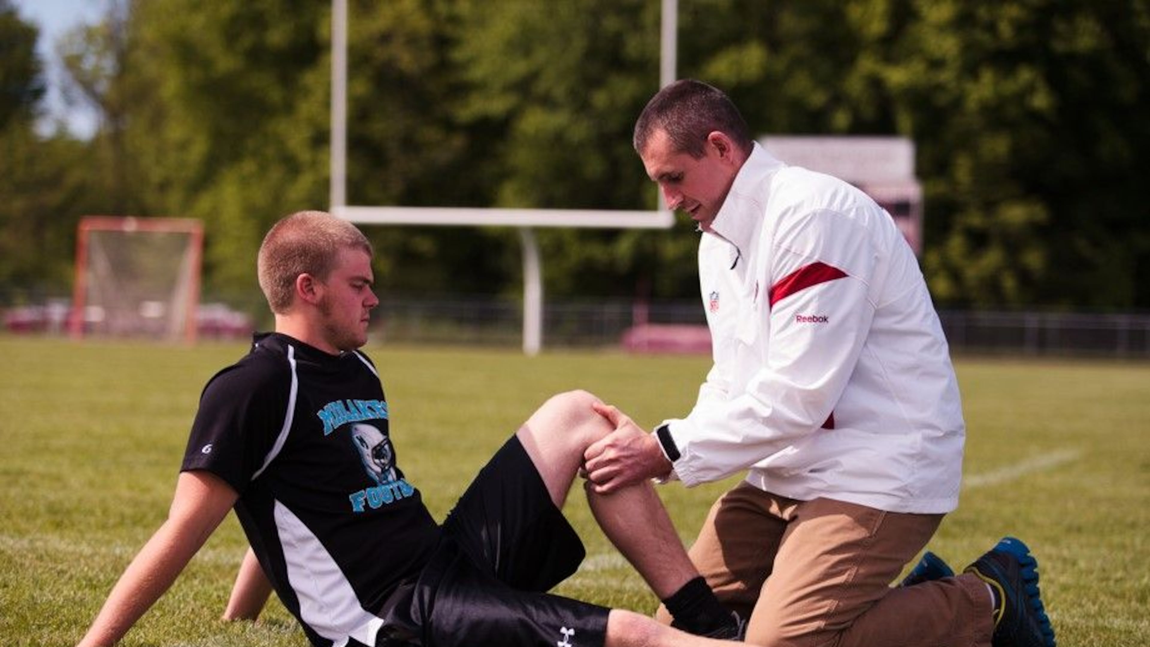 Dr. Christopher Brown works on an injured athlete.