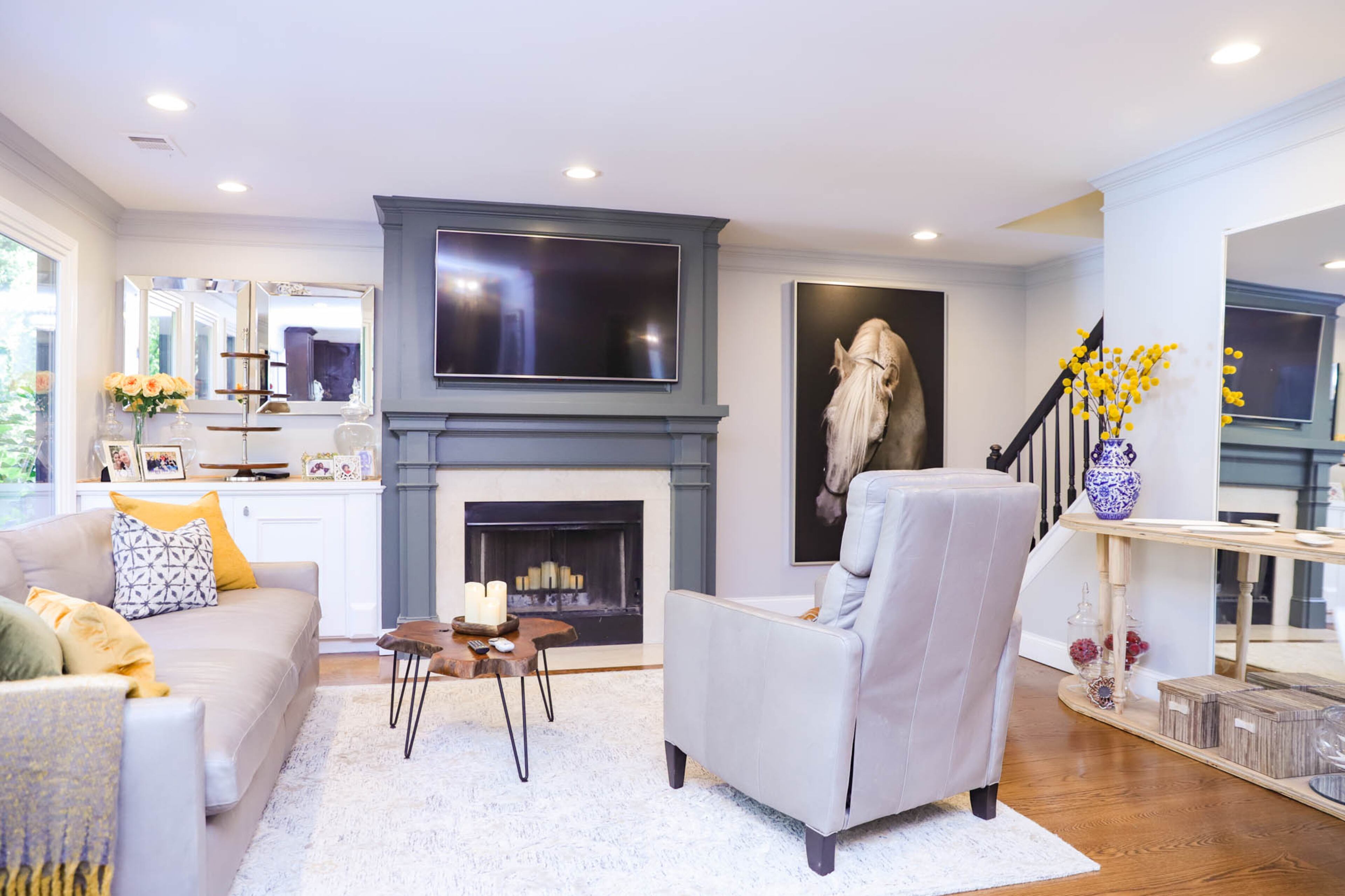 The family room of Liza and Kenneth Hare’s home is airy and stylish, with a sofa and chair from Arhaus, a rug from HomeGoods and a teak wood coffee table from Cost Plus World Market. This is the space where the couple relaxes and watches TV. When they renovated the first floor in 2018 Liza Hare reconfigured the fireplace, drawing out the design how she wanted it and working with a carpenter to bring it to life. Text by Shannon Dominy/Photo by Reynolds Rogers