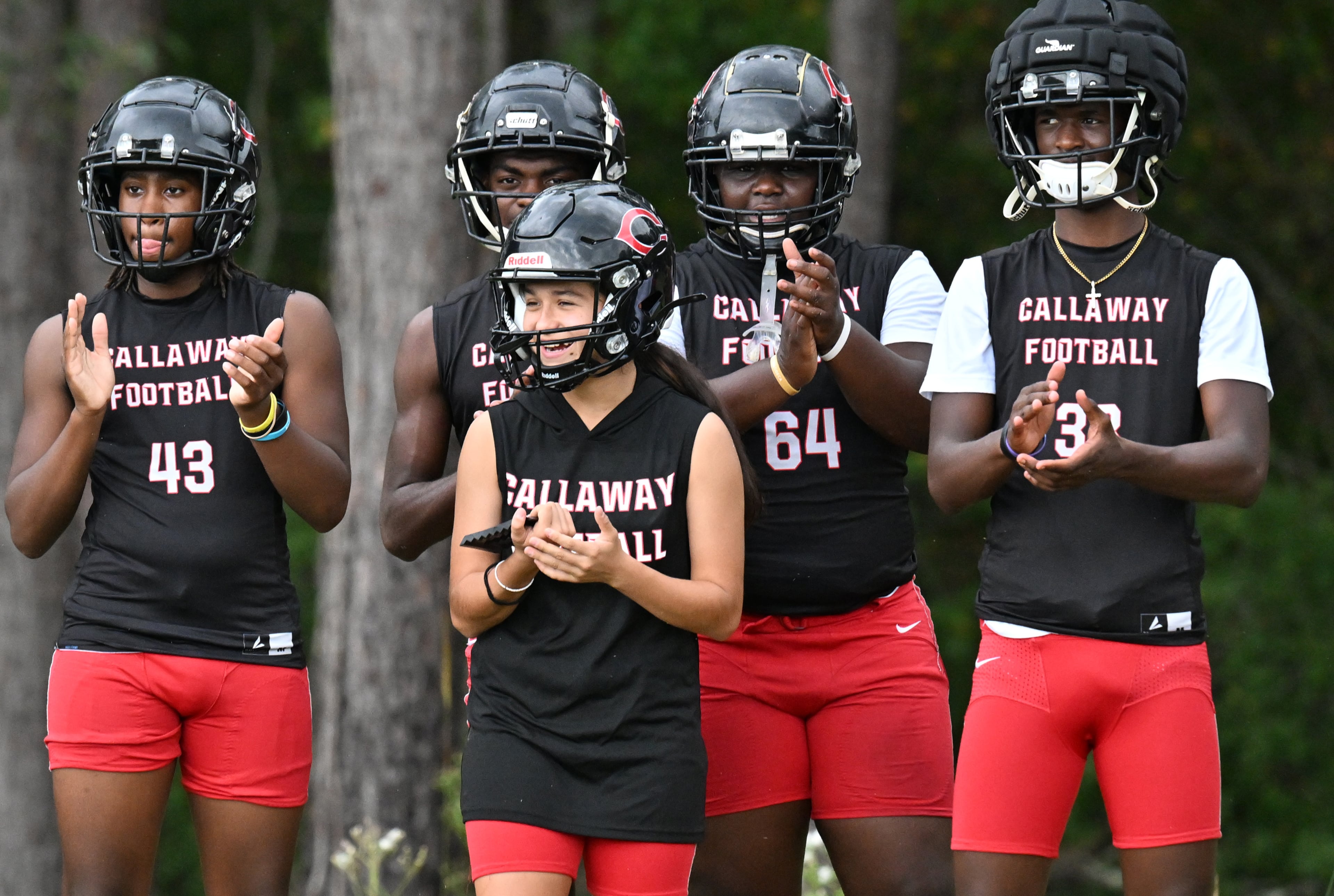 Mia Flores (foreground) runs through drills with teammates during football practice at Callaway High School on Thursday, Sept. 25, 2025, in Hogansville. (Hyosub Shin/AJC)
