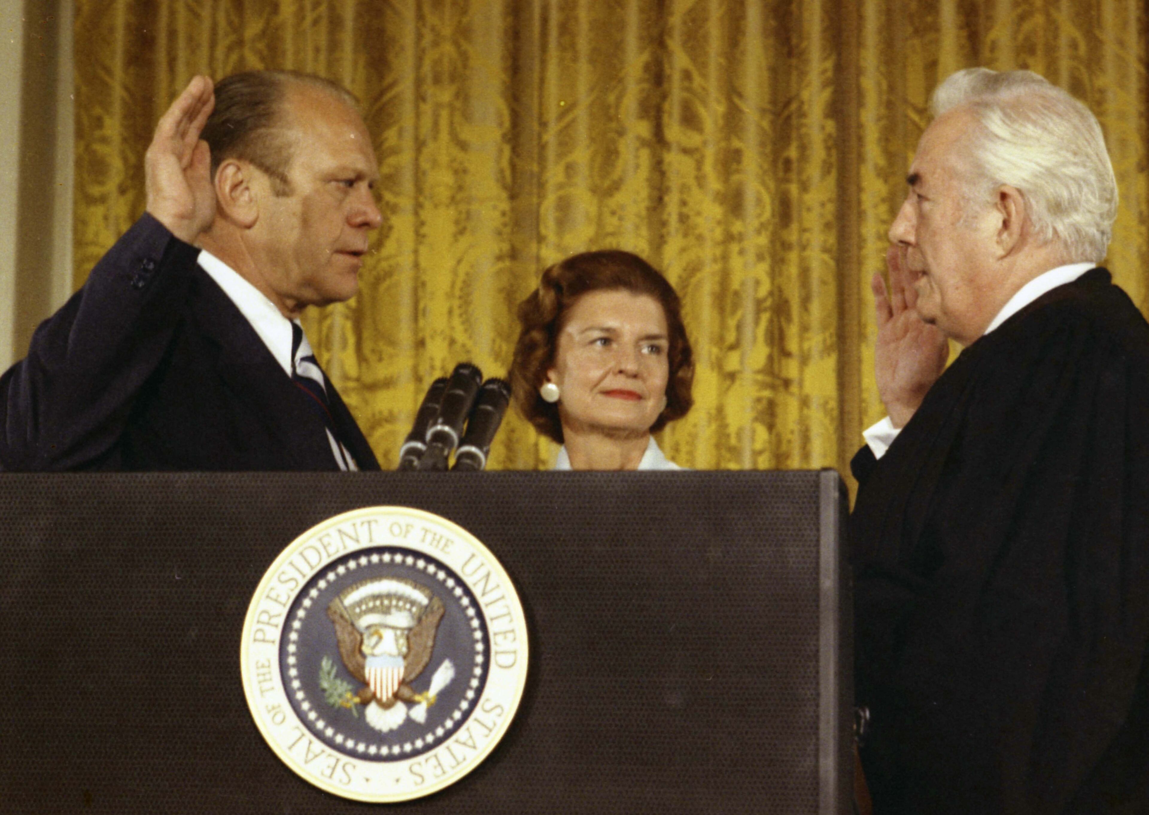 Supreme Court Chief Justice Warren Burger (R) swears in President Gerald Ford August 9, 1974 in Washingon, DC. Behind them stands First Lady Betty Ford who is probably best know for raising awareness of addiction creating the Betty Ford Center. (Photo by Robert L. Knudsen/Gerald R. Ford Library via Getty Images)