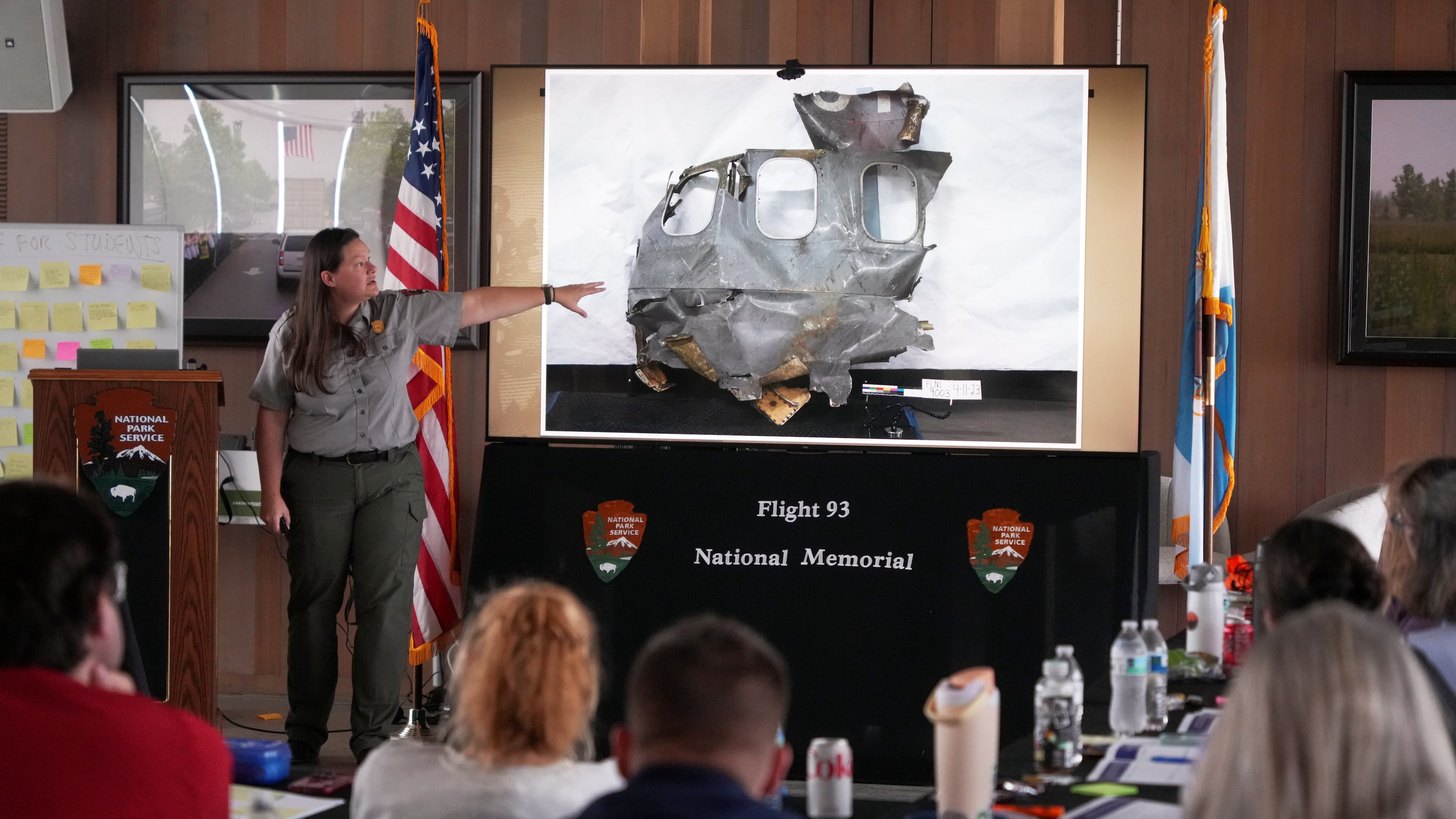 U.S. Park Ranger Betsy Keene, curator of National Parks of Western Pennsylvania, explains a slide showing a damaged part of United Flight 93 during an educators seminar at the Flight 93 National Memorial in Shanksville, Pa., Tuesday, June 23, 2026. (AP Photo/Gene J. Puskar)