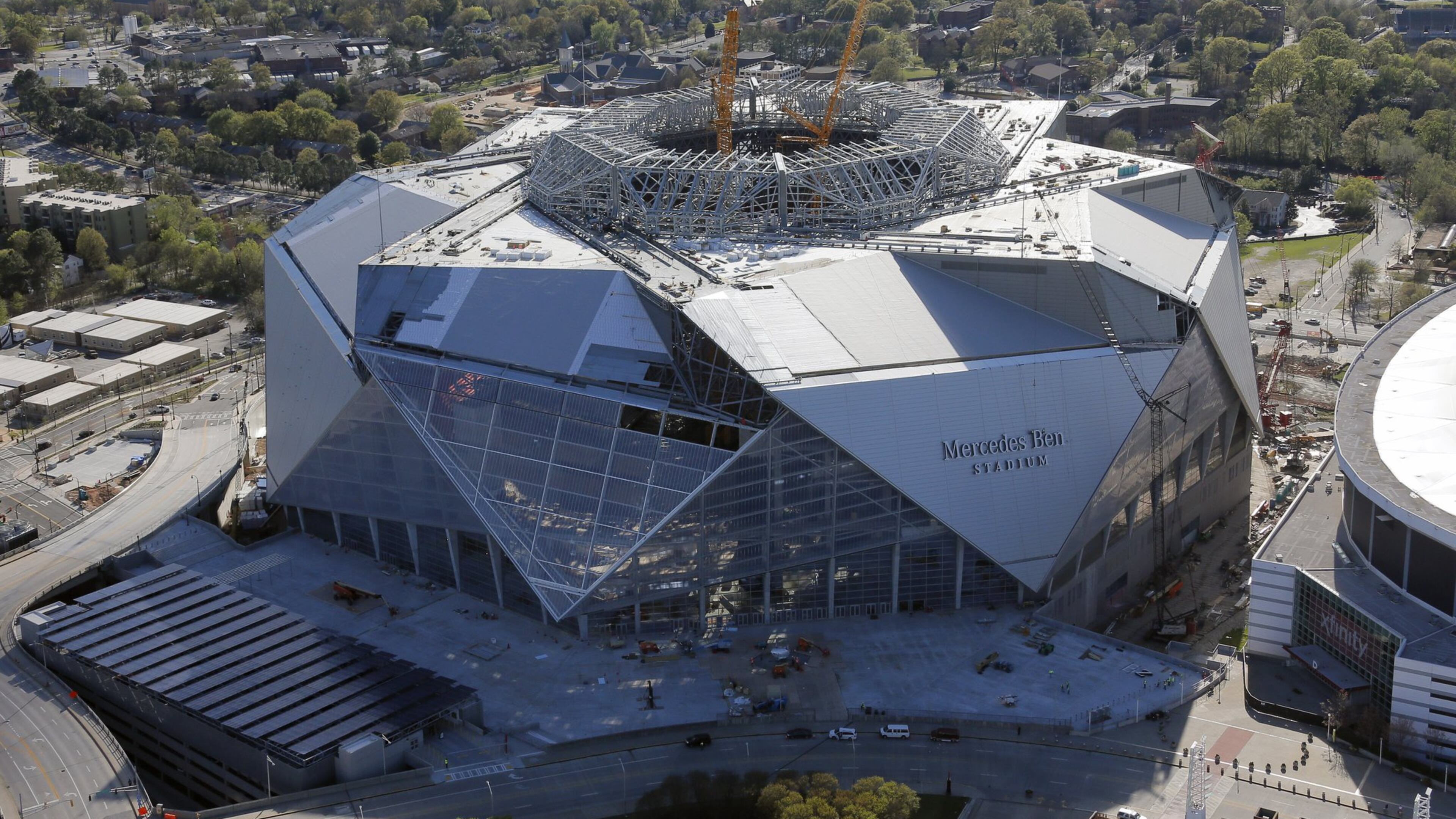 Mercedes-Benz Stadium sits next to the Georgia Dome. Aerial photo was taken last Friday. BOB ANDRES /BANDRES@AJC.COM