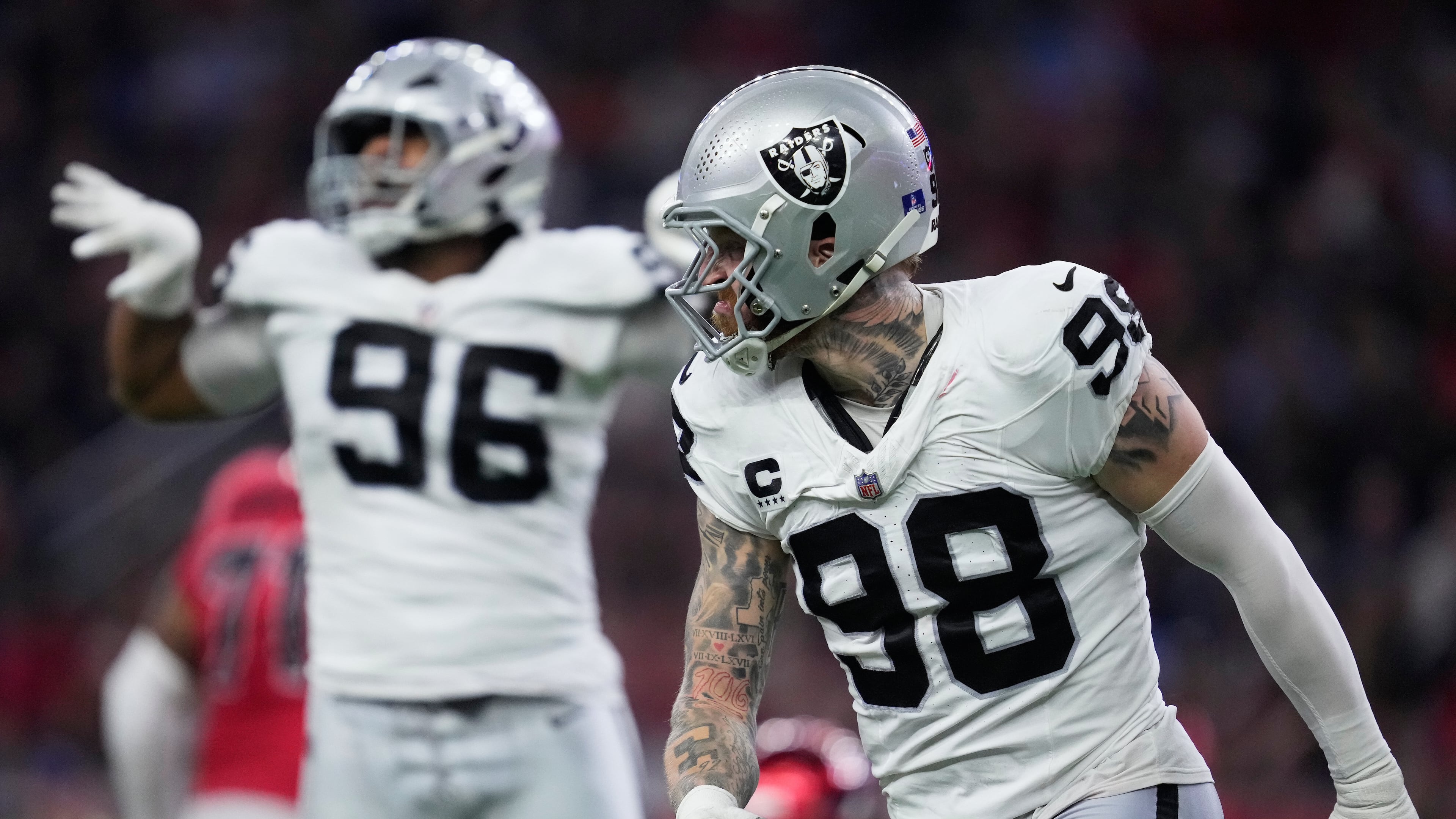 Las Vegas Raiders defensive tackle Jonah Laulu (96) and defensive end Maxx Crosby (98) celebrate during the second half of an NFL football game against the Houston Texans, Sunday, Dec. 21, 2025, in Houston. (AP Photo/Ashley Landis)